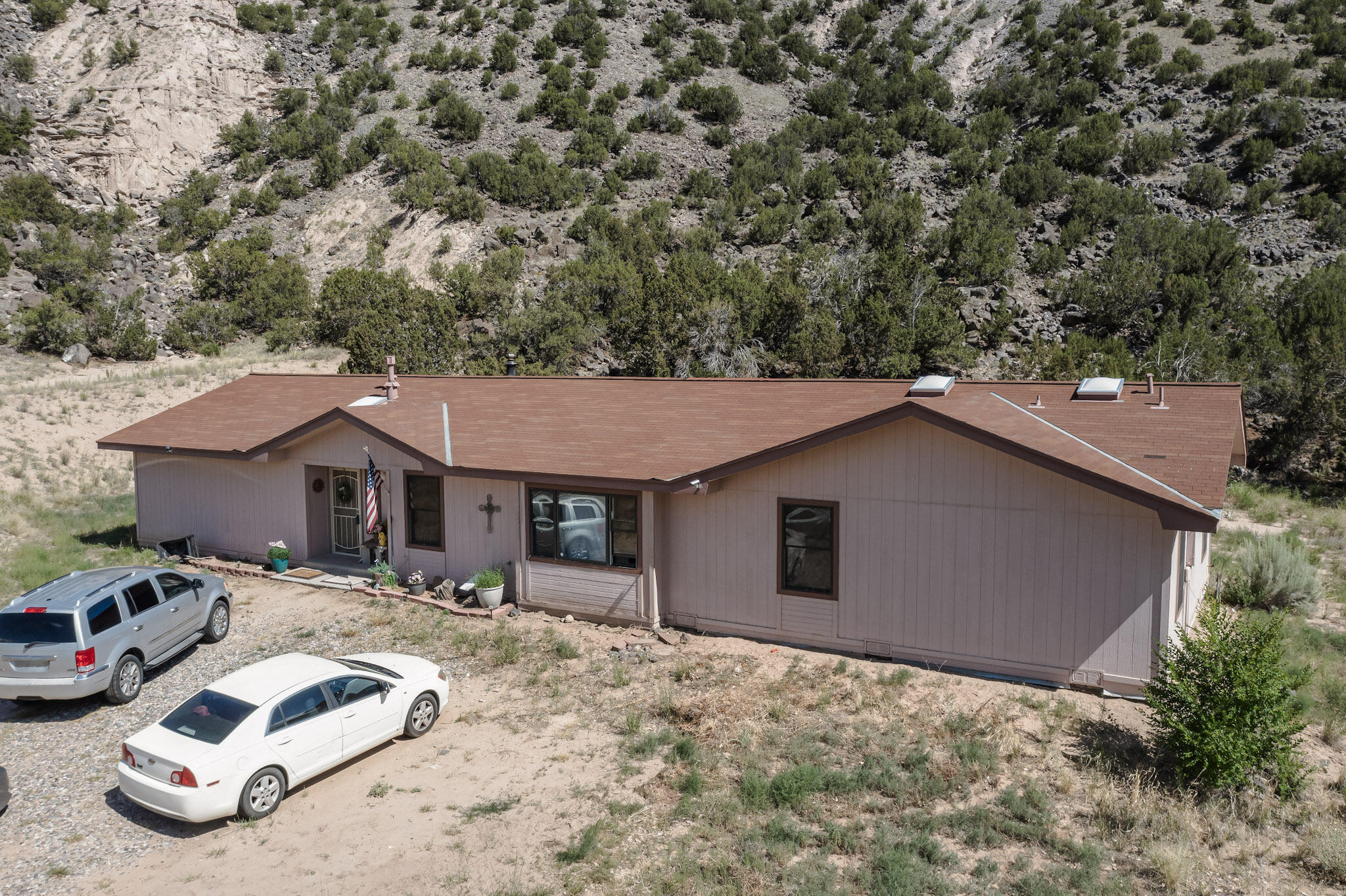 Your Northern New Mexico Retreat Awaits -- Just Minutes from Ojo Caliente Mineral Springs!Welcome to 34358 US Highway 285, a peaceful and private 5-bedroom, 3-bath oasis set on 1.66 acres of open skies, crisp air, and stunning high desert landscapes. Imagine waking each morning just minutes from the legendary Ojo Caliente Mineral Springs Resort & Spa, hot baths, and holistic wellness are part of everyday life.With 2,242 square feet of beautifully maintained living space, this home offers room to breathe, grow, and truly live. The spacious family and living rooms are filled with natural light and perfect for gathering. The tile flooring throughout is both elegant and low-maintenance, and a cozy fireplace adds warmth and charm.It won't last long