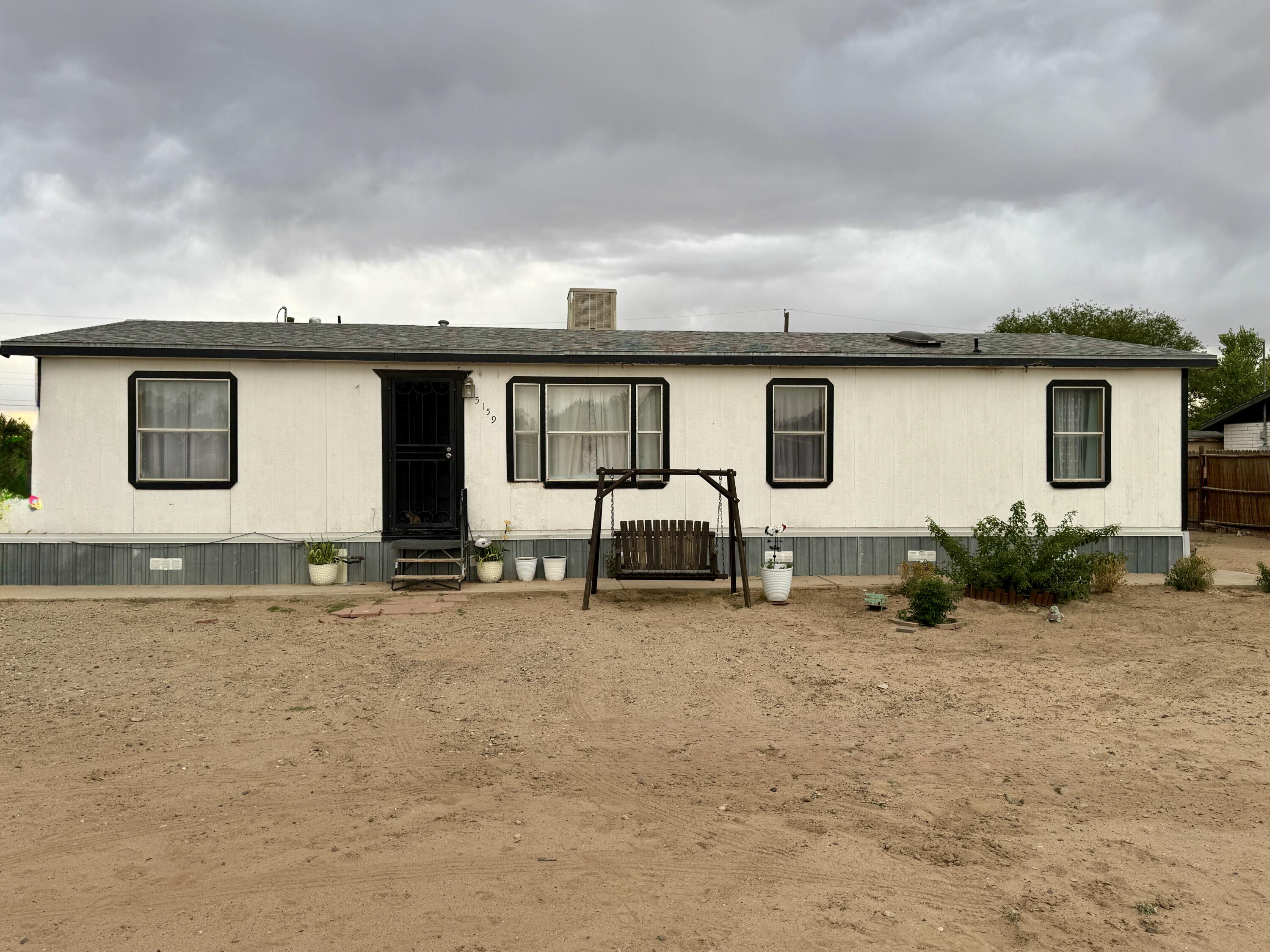 This spacious property has a manufactured home on a permanent foundation with 3 Beds & 2 Baths and is located in Los Chaves area of Los Lunas. The following were updated/installed in the last couple of years, laminate throughout main living areas, replaced carpet in bedrooms, remodeled baths and put in ceramic tile floors, updated light fixtures, ceiling fans in family/ den areas, new furnace 2025, stainless dishwasher, replaced plumbing water lines under home, 2 new doors on garage, built the porch on south side,  and added a walk in closet off main bedroom. The property is fenced and gated with backyard access and features a large Metal shop with space for 3+ cars with a private well pump house. Bring your horses or animals and make this your home today. Hurry this won't last long