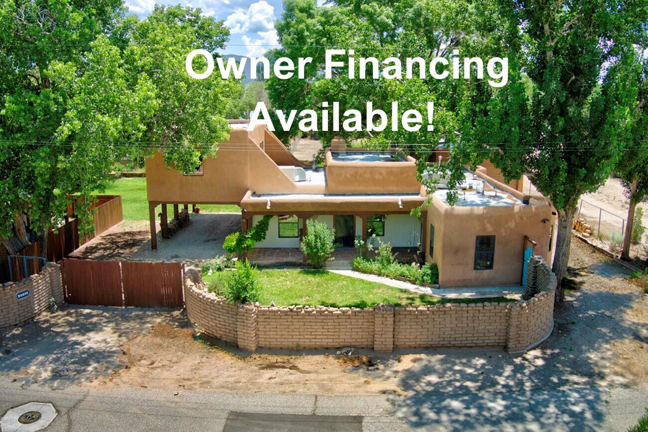 Seller will consider owner financing w 20% Dn. Rare N. Valley Opportunity- 2 homes on a .96 acre lot!  This one of a kind property offers incredible versatility & space. Ideal for multi generational living, rental income, or guest accommodations. Main house features new roof, 2 spacious bedrooms (1 w murphy bed), generously sized living room w kiva fireplace, high ceilings, a big kitchen & another living space upstairs w 1/2 bath & an office/bdrm. Primary has large walk in closet & fireplace. Casita is 1 bd & 1 bth.  A true standout is the 1341 sqft detached garage complete with 1/2 bath, space for your RV, multiple vehicles or a workshop! Car port off main house. Mature landscape w big shade trees, green grass & lots of rosebushes! Close to bike trails & access to I25