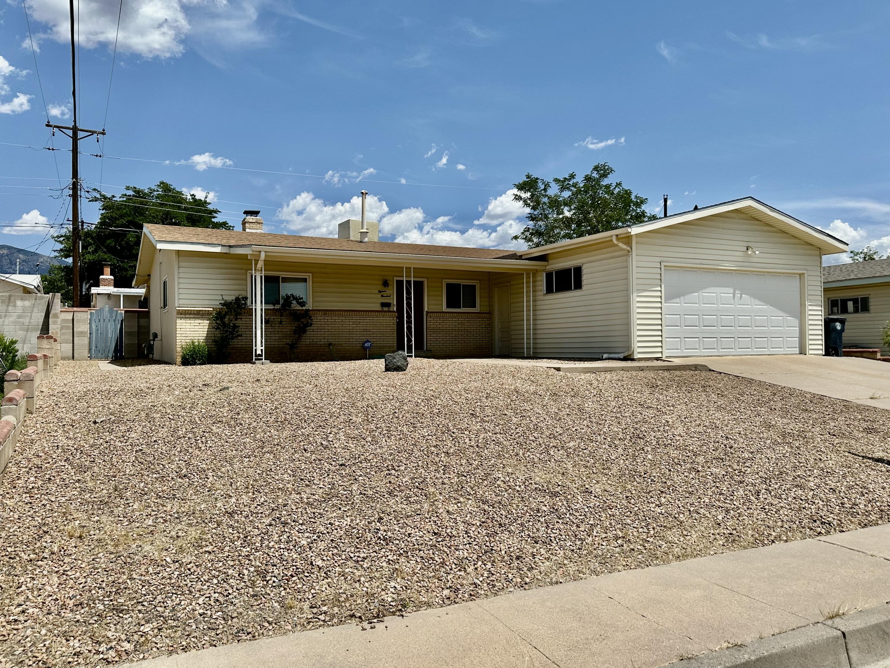 Elegant Remodel in mature and desirable neighborhood! The spacious living room is graced by a gorgeous 2-way fireplace that you can also enjoy while having a cozy meal in the Dining Area adjacent to the modern kitchen. The kitchen features granite countertops, lovely white cabinets, stainless steel appliances which include a brand new gas stove and a long bar with seating open to the Living room. Both bathrooms have been updated with elegant fixtures, lovely tile design and classic vanities. The covered patio opens to a spacious backyard! Enjoy the protection of a double car attached garage! Roof only 7 years old! Newer Electrical Panel and Water Heater under a year old! Wireless keypad/keyless entry garage door opener which the Sellers have not installed & ADT Alarm System incl.