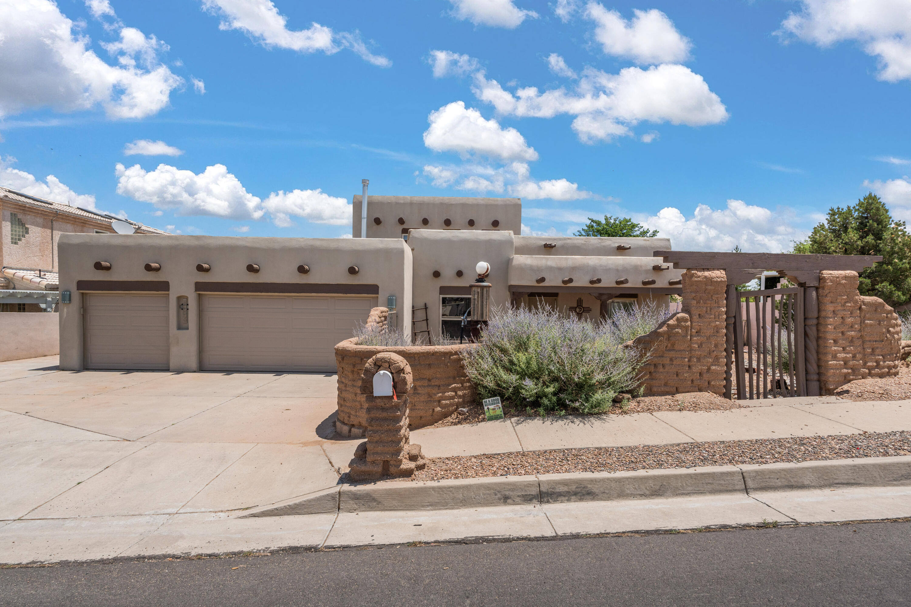 Do not miss this beautiful Southwest style home that was featured in Parade of Homes when built!   Enter into the private, peaceful courtyard  surrounded by adobe like walls.   The main entrance opens to a soaring ceiling with Vigas    Arched doorways give way to generous sized bedrooms    Southwester flair is evident throughout with latillas, nichos and custom doors and fireplace mantle.  The chef's kitchen had plenty of cabinet and counter space and a  kitchen island.  Despite the rustic look, all of the amenities are there!   Granite counters and  stainless steel appliances blend in seamlessly!   The primary suite is separate from the other bedrooms and the primary bath has a jetted tub and separate shower  The upstairs bedroom is a flexible space with amazing mountain and city views!
