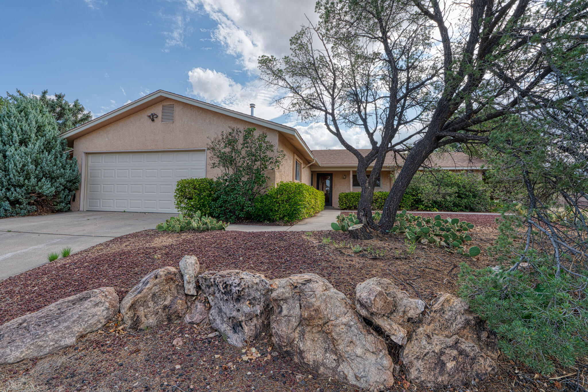 Don't miss this gem in a prime location near top-rated schools and great shopping! This spacious 4-bedroom, 2-bath home features two inviting living areas, two cozy fireplaces, and a beautifully landscaped, private yard with fruit tree, flowers, grass, and two patios--perfect for relaxing or entertaining. Enjoy side yard access, a large 2-car garage with extra space and a workshop bench, plus newer HVAC and water heater (all under 5 years old). The kitchen and baths shine with solid-surface counters and beautiful cabinetry. Home is wired for cable and fiber optic internet. All appliances, including washer and dryer, stay!