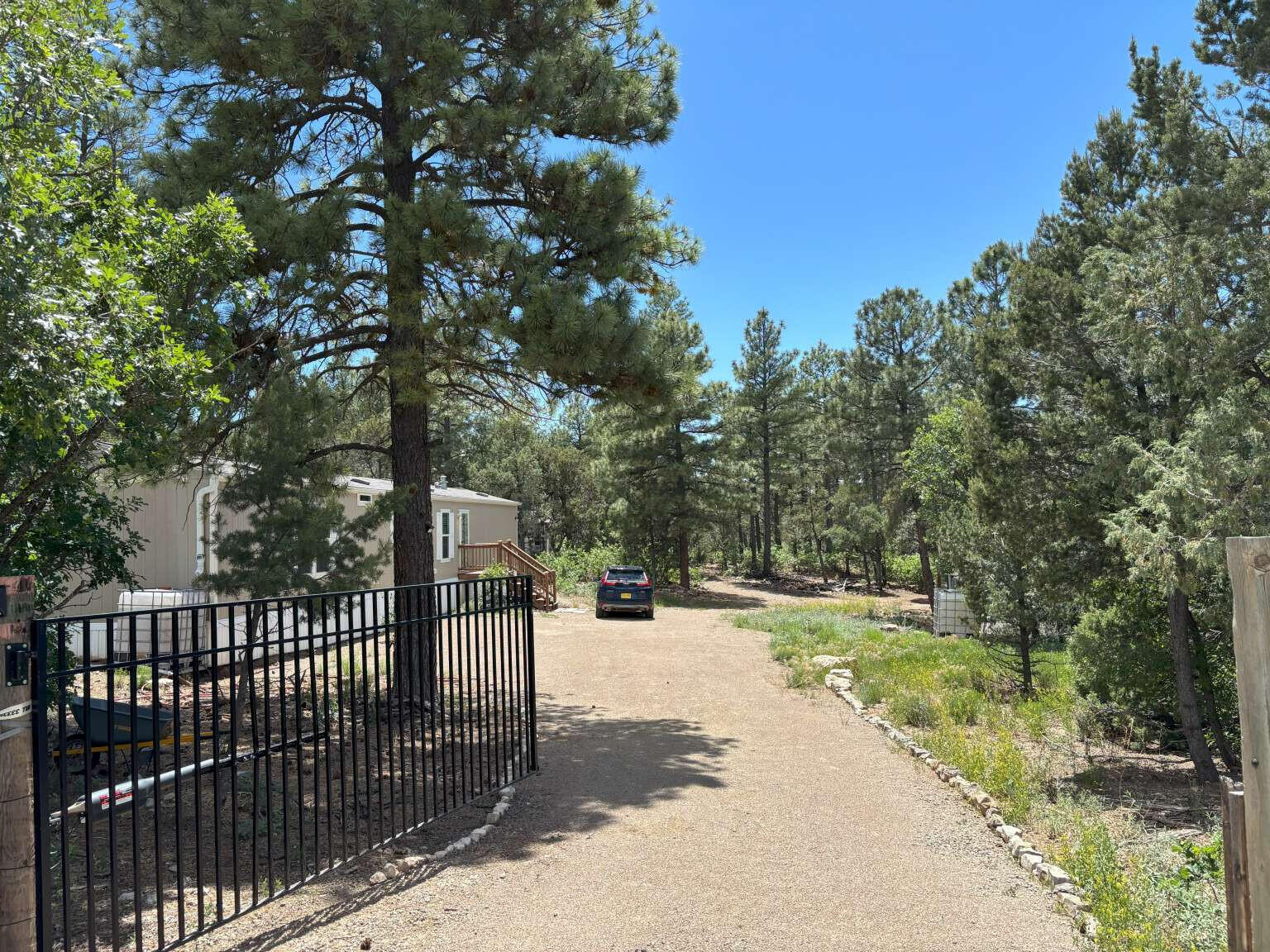 This is a peaceful off-grid property on 2 acres just 30 min from the middle of Albuquerque NM. It is beautiful and serene at 7600 feet of elevation with no direct neighbors. It is on a county road, so the county must plow snow. It has reception with T-mobile and Verizon. Septic system and rain water (~1,000 gal) drip system fenced garden. Mostly flat and usable 2 acres. Solar system (14 x 400 W solar panels, 12 kWh lithium iron batteries, 3,750 W generator, and 3.6kW 24V Outback inverter/controller system). Close to state and federal land for hiking, climbing, and mountain biking. Property has a 196 sq ft built shed on concrete foundation, tree deck, large hammock, back porch, swing, zip line, and picnic table. Move in ready! No HOA's. This beautiful property offers self reliance.