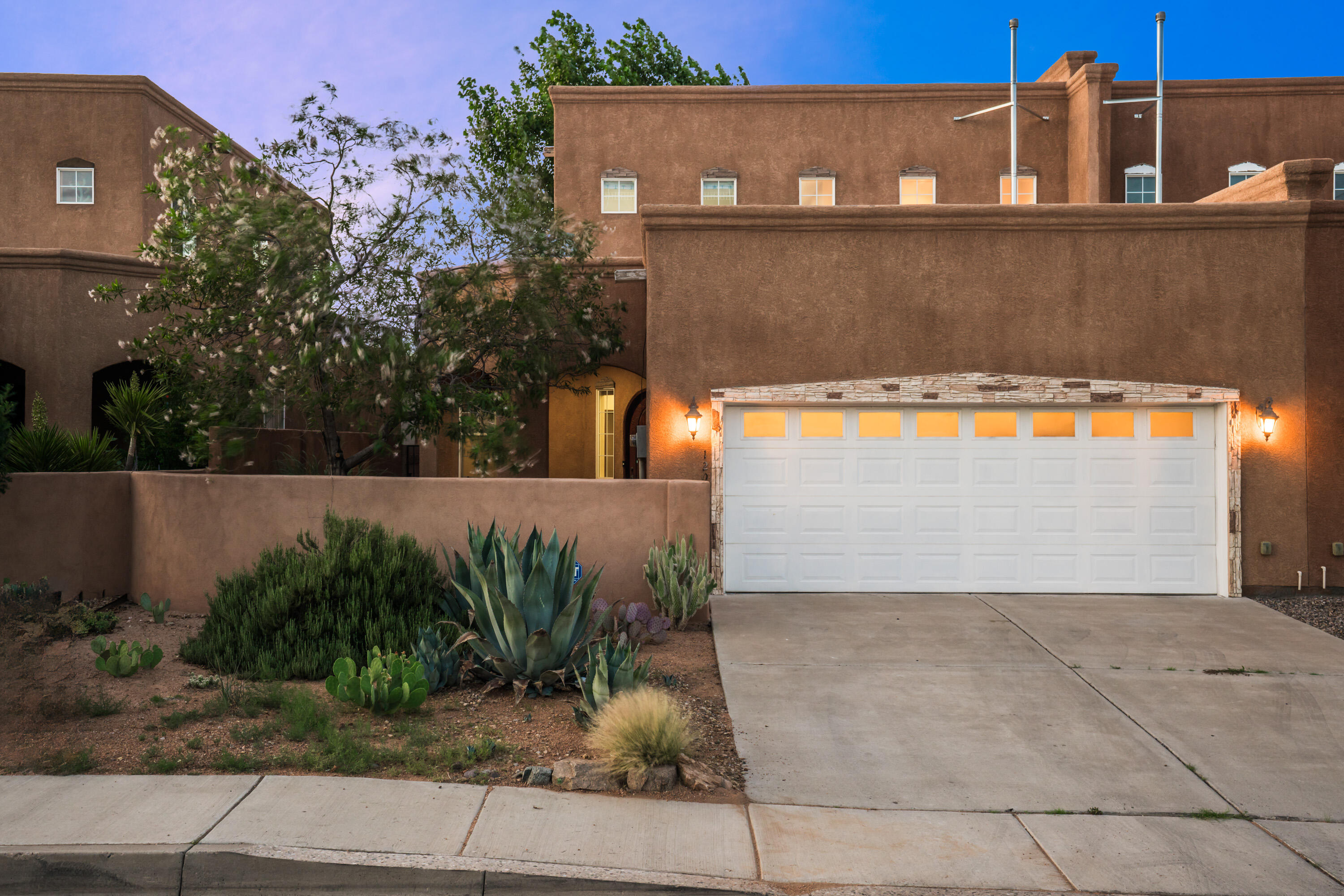 Rare opportunity in Albuquerque's coveted North Valley! Welcome to this elegant and spacious luxury townhome, perfectly nestled near 12th and Candelaria - NO HOA! This beautiful 4-bed, 3-bath home offers a versatile layout ideal for modern living. The bright, airy living space is enhanced by soaring ceilings and abundant natural light. The chef's kitchen is a true highlight, featuring rich alder wood cabinetry, granite countertops, stainless appliances, pantry, and generous prep space - perfect for cooking and entertaining. A downstairs bedroom with hardwood flooring offers flexible use as a home office, guest room, or private study. Spa-inspired primary suite with double-sinks, granite vanities, 2 walk-in closets, private balcony. Refrigerated air, water softener for year-round comfort!