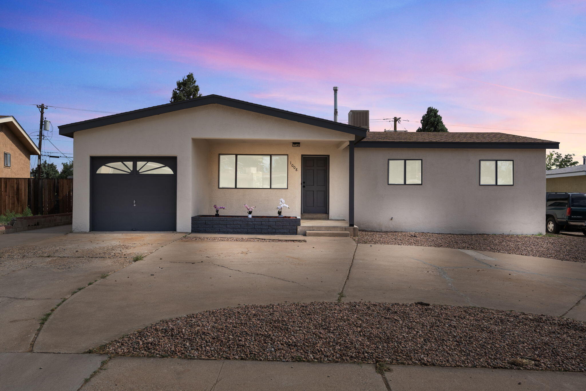 From the moment you arrive, the striking curb appeal of this beautifully remodeled home captures your attention. Step inside to discover fresh paint, new windows, updated bathrooms, and refinished hardwood floors that flow seamlessly with sleek tile accents. In the kitchen, recessed lighting brightens the space, highlighting the white cabinetry, bold white tile backsplash, and top-of-the-line new appliances. The open layout creates a bright and inviting atmosphere throughout. The living room, centered around a stunning fireplace, blends warmth with elegance. The primary suite offers a peaceful retreat with an ensuite bath. Outside, a covered patio opens to a spacious walled backyard. Every detail of this home has been crafted to perfection, offering a seamless blend of style and comfort.