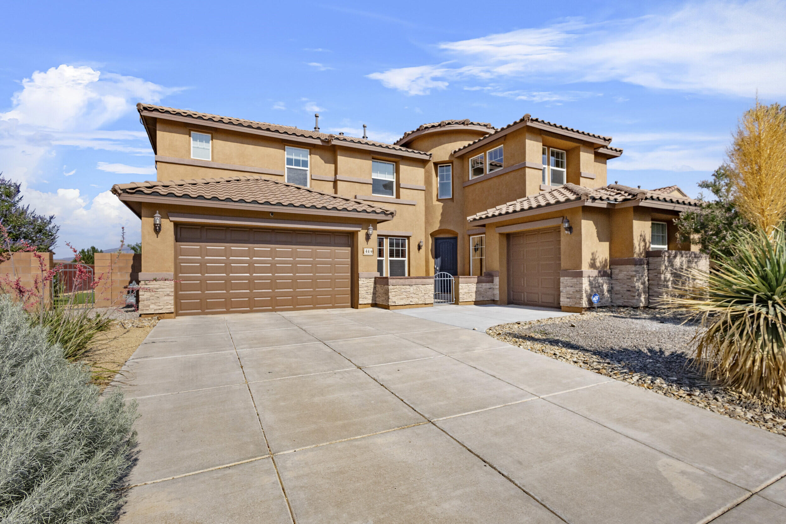 Luxury meets functionality in this stunning 6 bed, 4.5 bath home, perfectly situated on a corner lot off a cul-de-sac!Features include tier 3 granite counter-tops with custom Mountain Design Granite backsplash, SS appliances, & an OWNED $33k + solar system powering the entire home! New AC units installed in 2021. Spacious layout offers a second primary suite on 1st floor, 3 living areas, a home office, in-law suite, large mudroom, upstairs laundry, and a 4car garage. 1 bay with wrap-around mirrors perfect for a home gym/studio. Other updates include newer water heater, raised backyard wall, fresh landscaping, gorgeous shutters throughout common areas, possible backyard access, and a custom gas fire-pit in the backyard. STUNNING Sandia views from the primary balcony, don't miss this one!