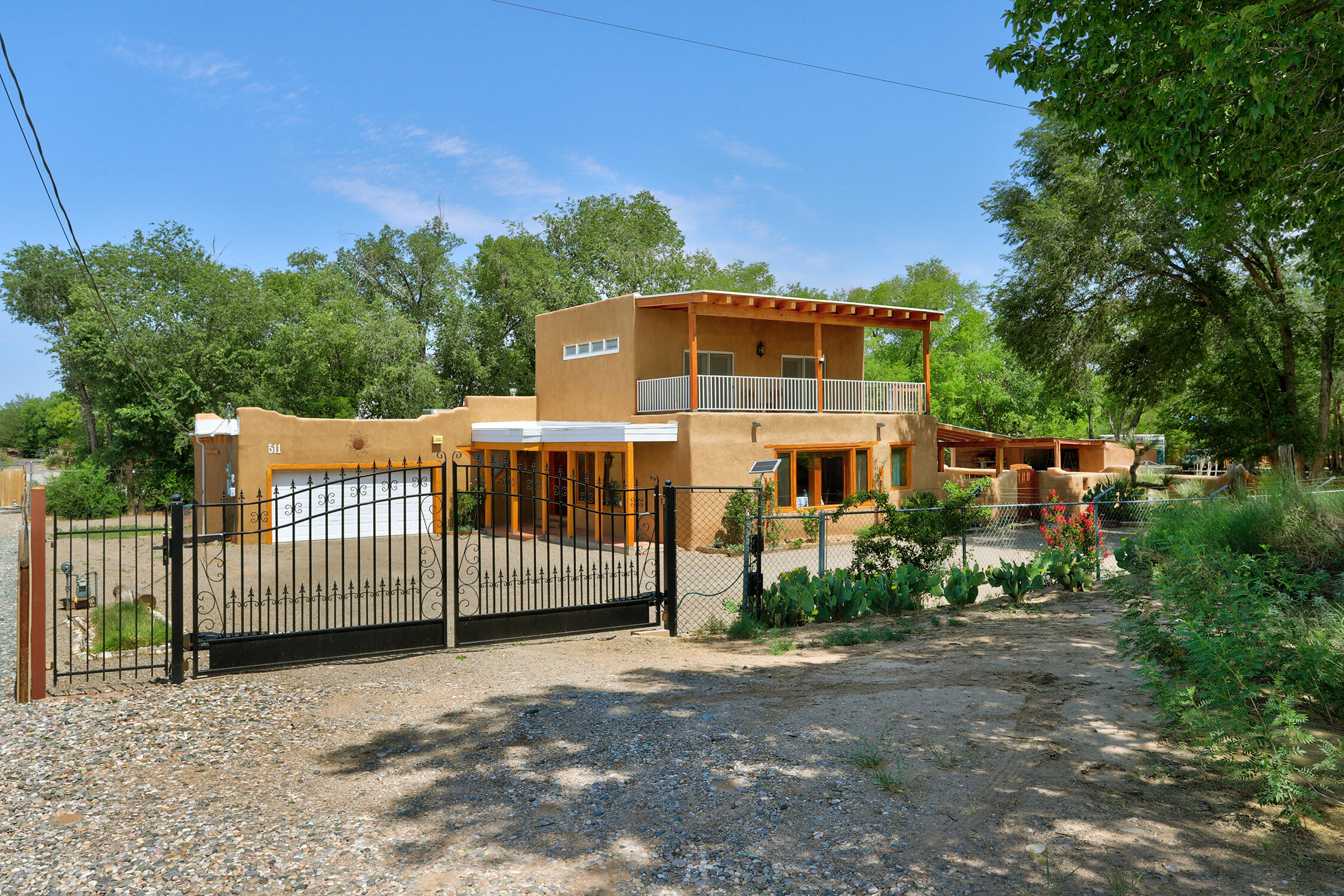 This is truly Country&#8209;living in the city! This Southwest charmer features exposed adobe, wood&#8209;beam ceilings, saltillo tile and wood floors. Features include refrigerated air, bonus room for office/dining/den, and a large loft upstairs with newer 3/4&#8209;bath addition and covered balcony boasting mountain and city views. Step outside to a private patio/courtyard, garden area with space for fruit trees, and potential for horse cover, chicken enclosure, plus a storage shed/workshop. Enjoy direct access to the MRGCD irrigation ditch and a private domestic well all on .55 Acre.