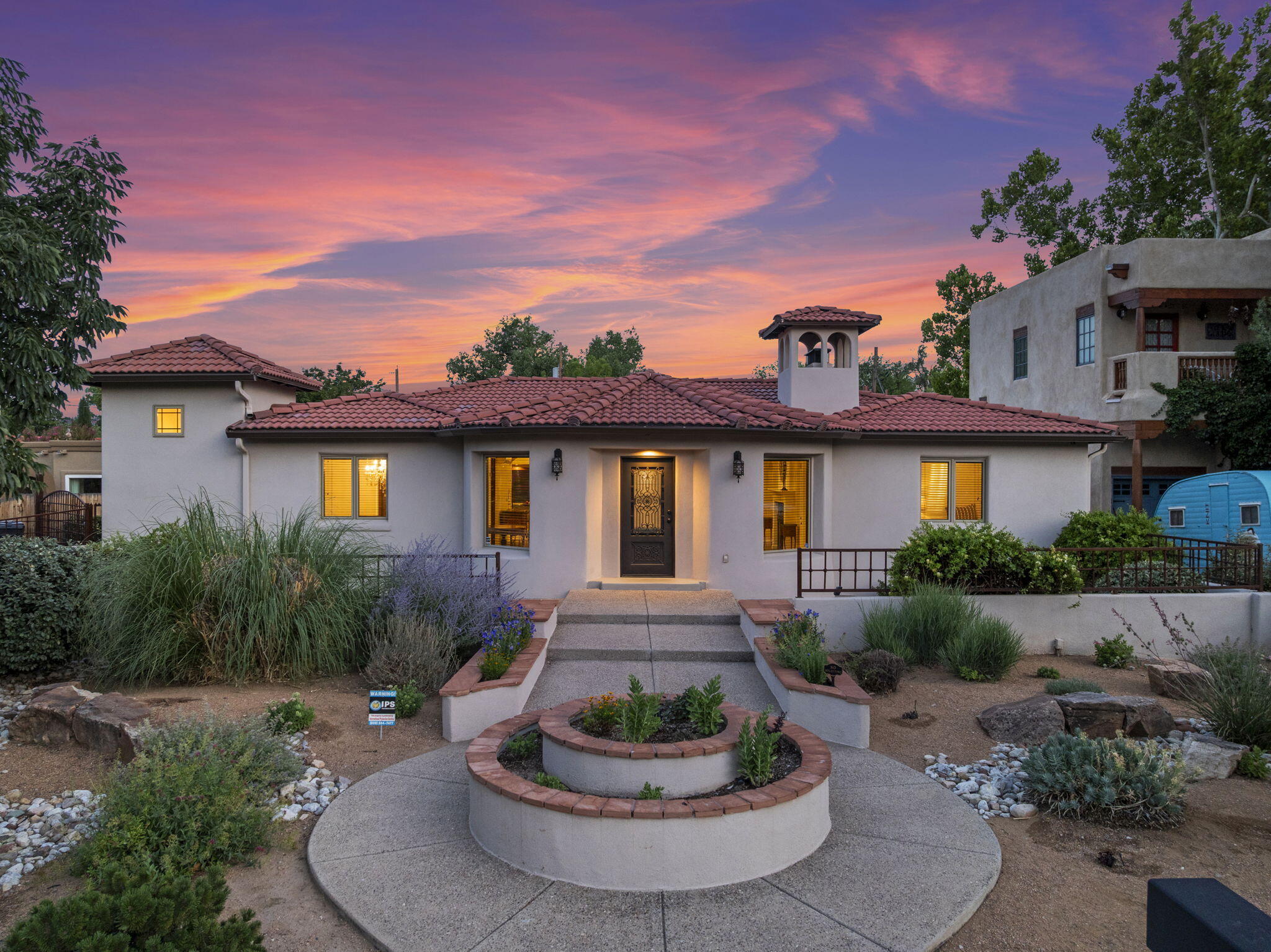 Welcome to this beautifully re-imagined Tuscan-style residence in the prestigious Albuquerque Country Club. Enjoy the main living space with beautiful well maintained hardwood floors, spacious primary suite, 2 additional bedrooms or a home office, chefs kitchen w/custom cabinets & stainless steel appliances. The finished basement offers, plush new carpeting, an inviting entertainment room, and a stylish wet bar--perfect for hosting in style. Updates include: Pella windows, LED lighting, HVAC & mini splits. Detached 2 car garage & shed adds extra storage. Come experience its charm today!