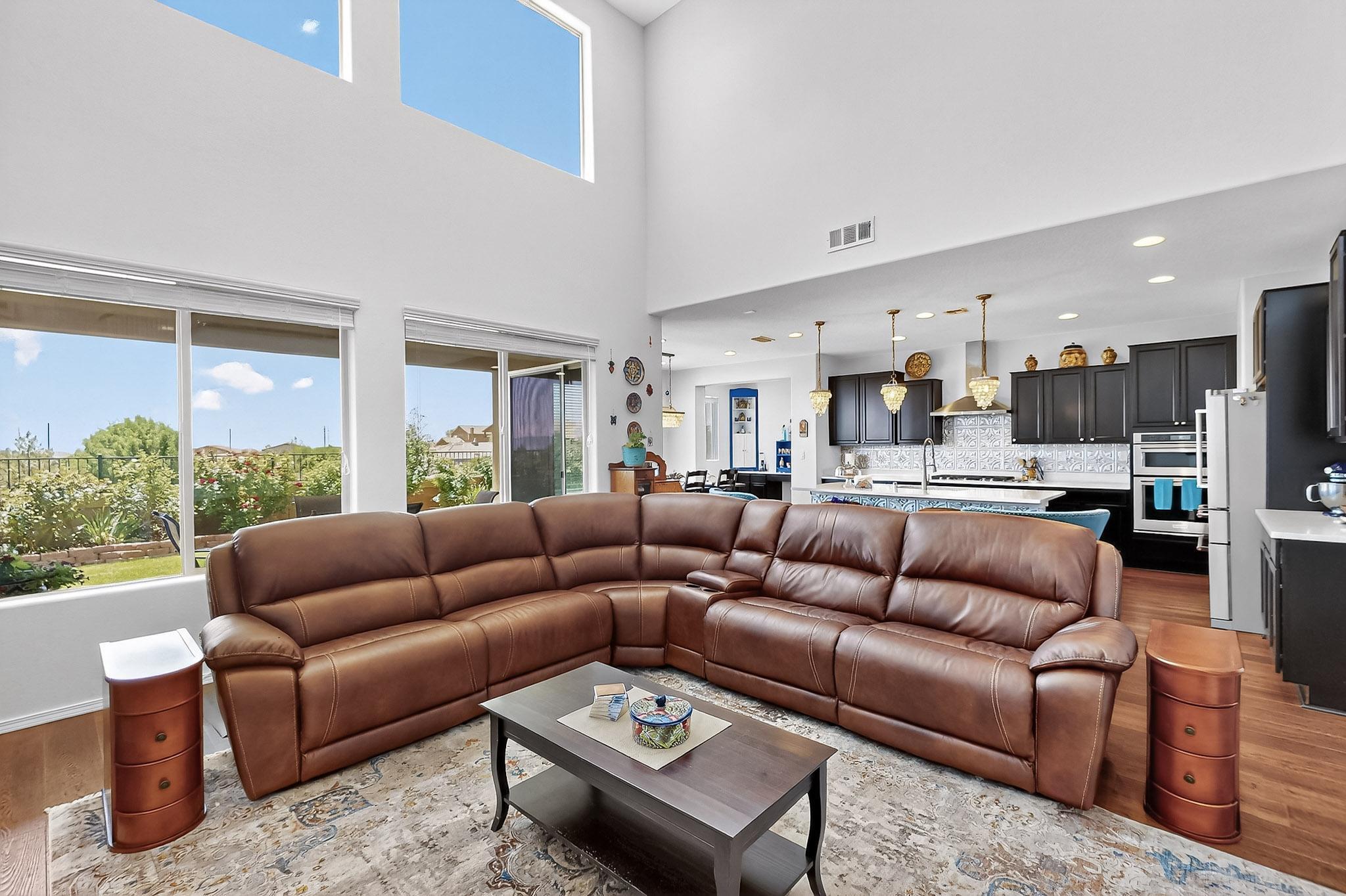Welcome to this highly upgraded Pulte 4 BR family home with two living areas, including a living/family room with a  2-story soaring ceiling with a panoramic window wall, plus an open upper loft area perfect for a pool table, playroom or movie/TV room with mountain views. Downstairs you'll enjoy the open plan with a cozy gas fireplace in the spacious living area, a large center island in the kitchen welcomes you, plus an eat-in area and separate, custom wine alcove /bar with storage.  The kitchen & ''Butler's''  pantry countertops feature stile stone with a punched tin backsplash, there's also a deep, multi-shelved pantry for lots of storage. Upgraded appliances include a Kitchen Aid cooktop, oven/microwave, & dishwasher & instant hot water dispenser.  Tap MORE for add'l information.