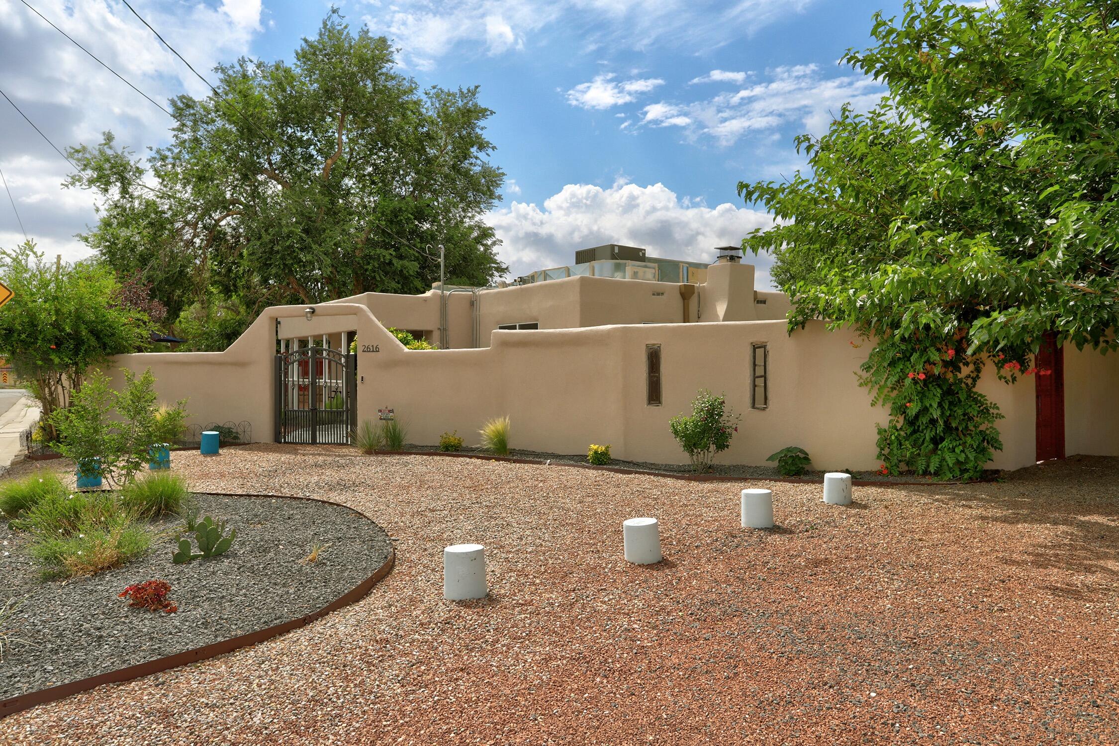 This beautiful home seamlessly blends timeless character & charm with modern amenities.  Set on a private, secure half- acre lot just a short walk from Old Town, Saw Mill, downtown & the bosque. Natural light fills the home creating a cheery, welcoming space. Sellers made over $250,000 in improvements in 2022 including a completely remodeled kitchen and remodeled baths, new flooring, new centrally ducted HVAC system, addition of a garage, California Closets and the list goes on. A complete list of improvements is available under documents. The detached 652 sqft studio is perfect for a private art studio or working space and/or gym but could be transformed into an additional dwelling unit. The irrigation well allows for endless possibilities regarding landscaping or urban farming.