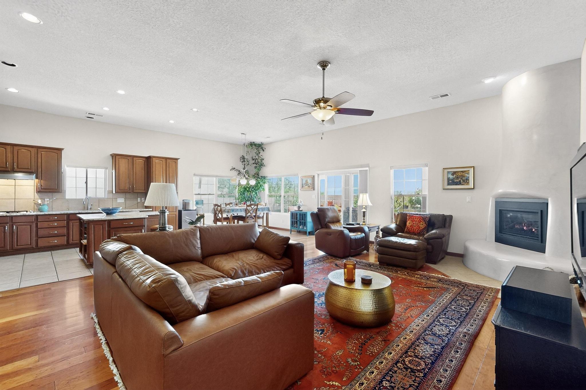Located in the Petroglyph neighborhood with a grassy, green community park that includes a children's play area, grills and picnic tables and close to the Petroglyph trailhead & walking trails. This bright and light home enjoys an open feel between the entry foyer, living room, kitchen/breakfast and dining areas.  Off the foyer you'll find a den with floor to ceiling bookshelves with a library ladder and a large front window.   The walls have a skip trowel application and the fireplace in the great room has a diamond trowel finish. This gas fireplace is also a Millivolt with an interior heating system, newer flue, plus a newer fireplace insert and remote starter.The owner's suite is spacious with a large window looking out to the rear yard with an array of red, pink,...,,SEE MORE !!