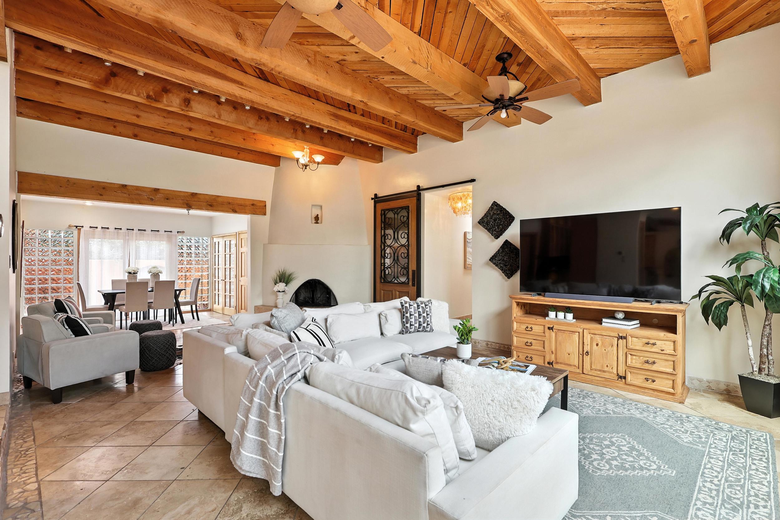 Welcome to this beautifully updated and truly unique single-story home on a spacious .78-acre lot with stunning views! Enjoy a kitchen with a commercial Wolf stove, Sub-Zero fridge, granite & quartz countertops, custom cabinetry, and a large island perfect for dining or prep. Multiple flexible living spaces, two custom fireplaces, and designer-tiled bathrooms add charm and function. Owned solar, refrigerated air, new water heater(2025), and a new septic system (2021) offer peace of mind. Outdoor entertaining is easy with porch access from living areas. A 3-car garage and side yard access provide ample storage and convenience.