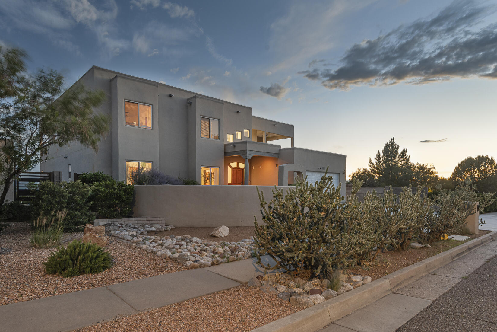 This stunning home nestled in the Sandia Mountains offers breathtaking views of the mountains, cityscape, Bosque, and volcanoes. Meticulously maintained, it features multiple outdoor patios creating ideal spaces for relaxation and entertaining. The functional kitchen seamlessly opens to the living and dining areas, making it perfect for gatherings. The large primary suite boasts a walk-in closet and double vanity, providing comfort and convenience. The spacious living area with high ceilings is filled with natural light, enhancing the warm and inviting atmosphere. The lower level offers an additional living space with its own kitchen, 2 bedrooms, and 2 baths, along with a patio and backyard access--an excellent setup for multi-generational living and versatile living options.