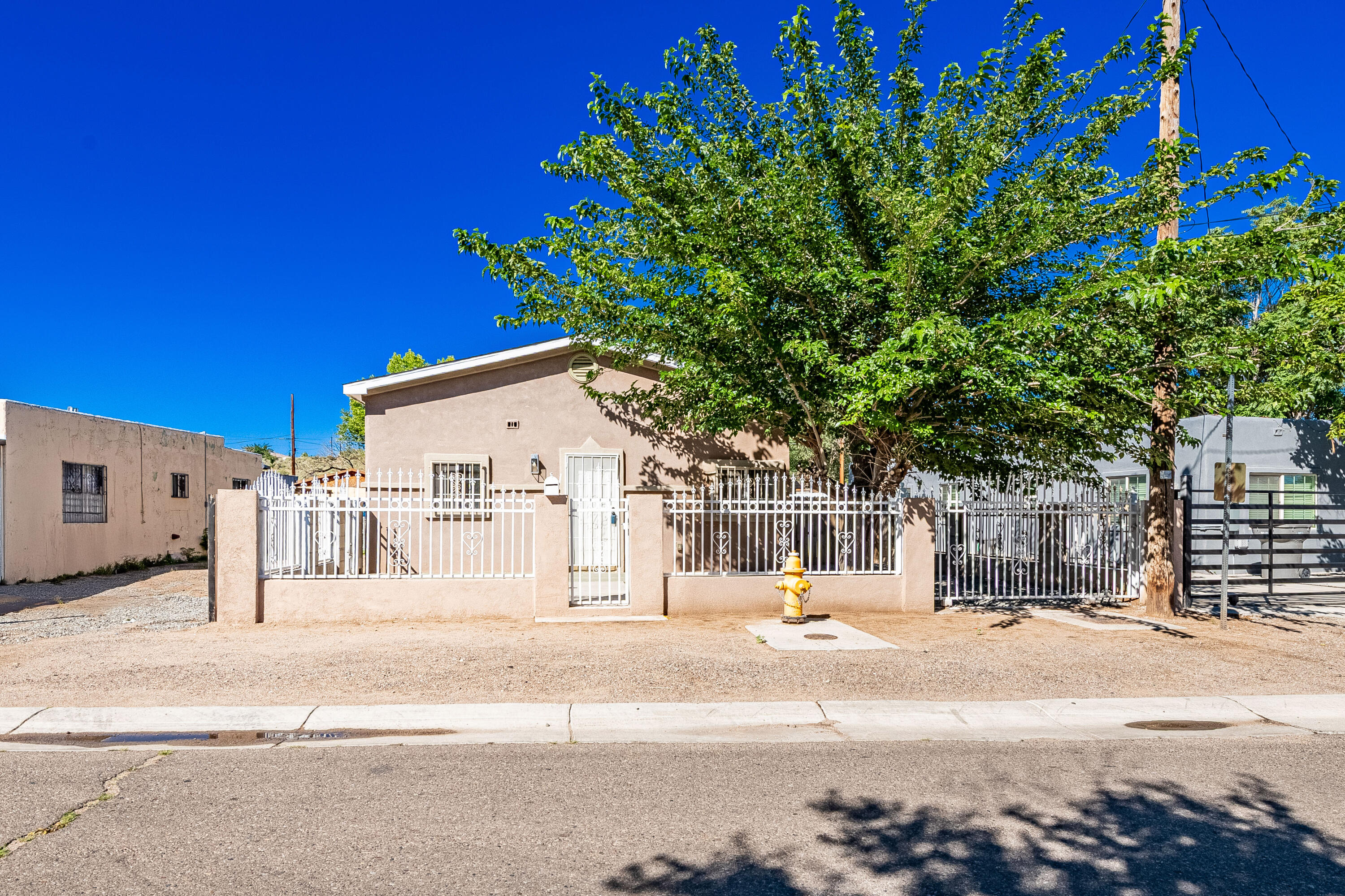 Charming bungalow-style 2-bed, 1-bath home with tons of character! Features synthetic stucco, a pitched roof, and a spacious backyard with full access. Enjoy refrigerated air, tile flooring in the kitchen, living, and bath, plus brand-new carpet in the bedrooms. The oversized lot is fully fenced for privacy and security. Bright and airy interior with abundant natural light throughout. The front yard boasts low-maintenance Southwest gravel landscaping. A perfect blend of comfort, space, and style--don't miss this one!