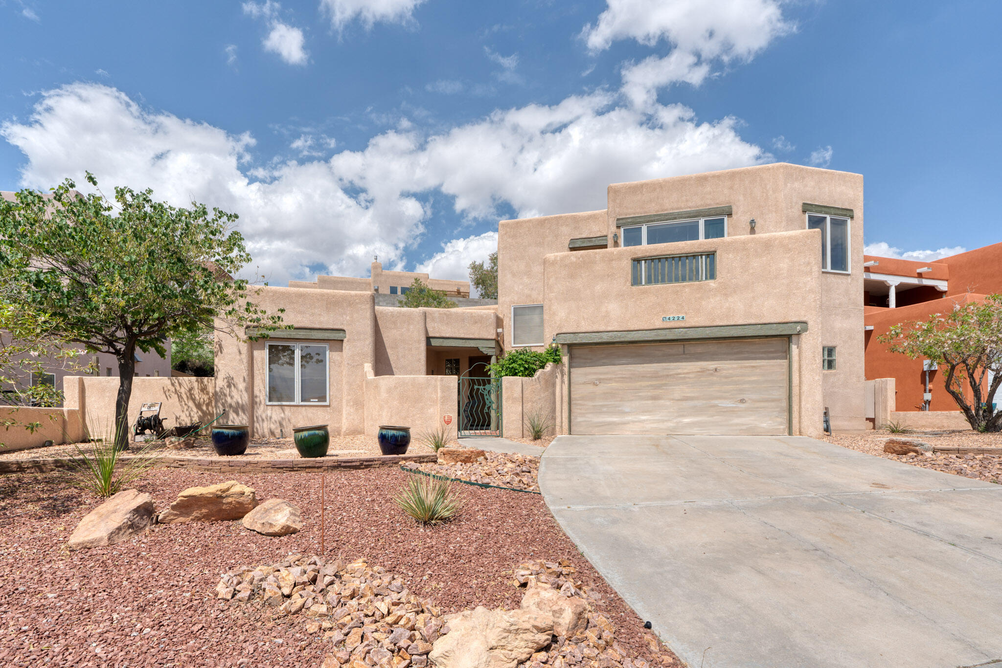 Enjoy sweeping mountain views from your balcony in this beautiful home near Coors & Paseo del Norte! Bright, spacious interiors feature large windows, ceramic tile throughout, and walk-in closets in both bedrooms--including dual master closets for extra storage.PYou'll love the walk-in pantry, storage under the stairs, and oversized garage for all your needs. Unique artistic gates add charm and character to this one-of-a-kind property.