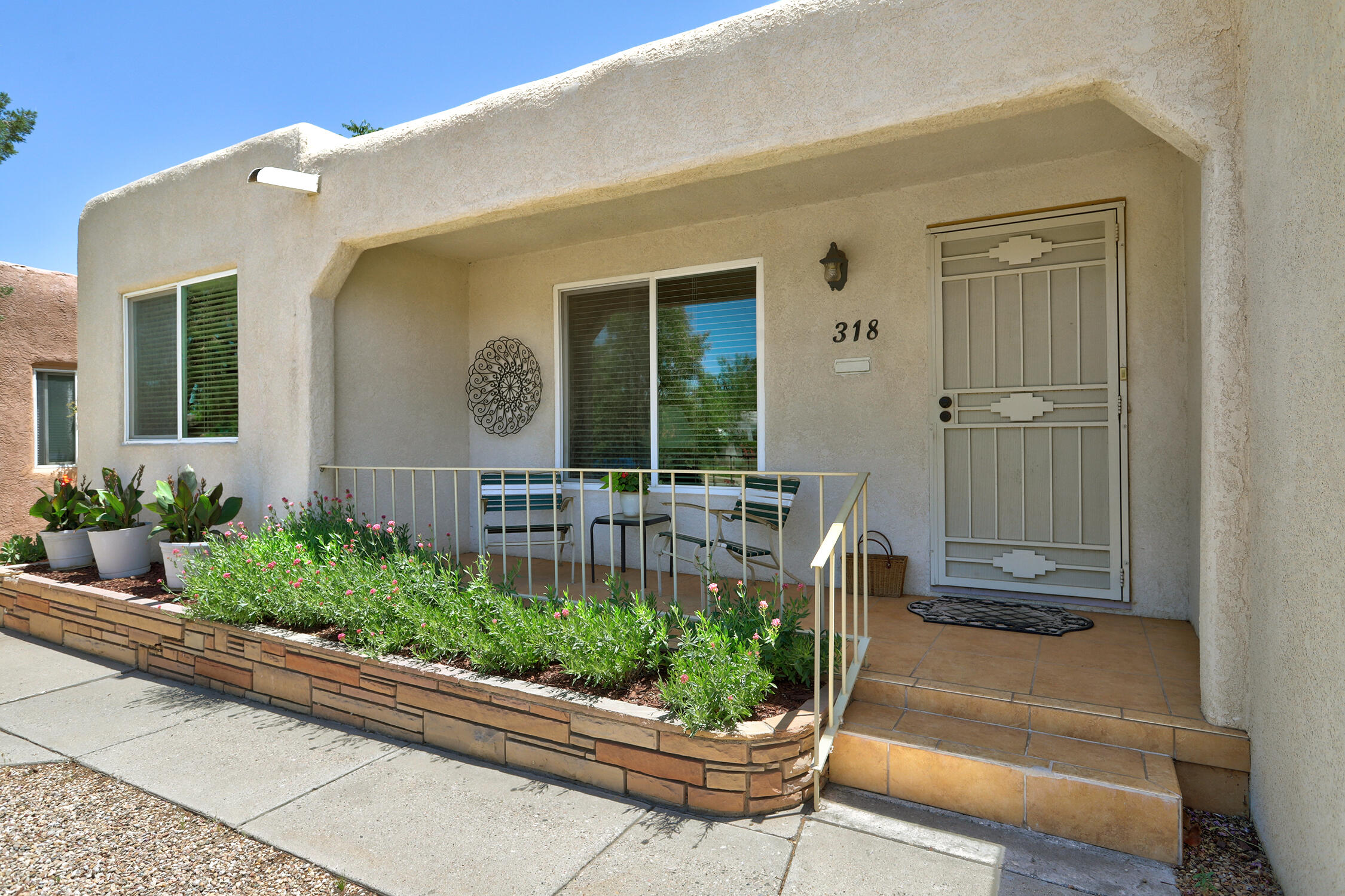 Pristine UNM 2 BR home complete with xeric front and a serene backyard oasis!  You'll  love the charm of hardwood floors, wood burning fireplace, updated eat-in  kitchen with gas stove. Relax in the den by the fireplace or outside on the covered patio-great for a quiet retreat or entertaining! Other upgrades include the bath, windows, stucco. Large laundry room with extra storage-washer & dryer stay. Hard to find detached 2 Car Garage with alley access. Convenient mid city location close to grocery shopping, UNM,  Nob Hill and everything you need!