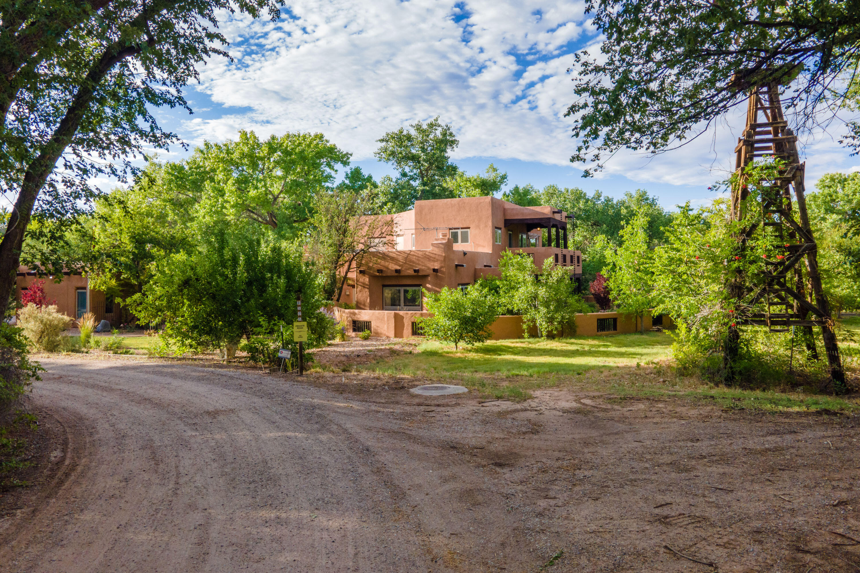 Iconic partial Adobe on .87 acre located on a quiet lane beside a meandering ditch, the lifeblood of the Valley. Peaceful sounds of birdsong & breeze rustling age old leaves above surround you.  Courtyard entry leads to traditional brick floored living & dining spaces w/vigas & frplc. South sun streams in the wall of windows leading to main flr bdrms including large primary retreat w/reading nook, access to covered patio,walk-in closet & spacious bath w/separate tub & shower & dbl sink. Fabulous 2nd living area/game room & library offer additional places to gather. Upstairs find full bath & 2 generous bdrms w/access to covered portal overlooking orchard w/25 fruit trees & 8 raised beds.  Irrigation well and irrigation access..3 car garage w/evap cooler. Enjoy miles of ditch trails & natur