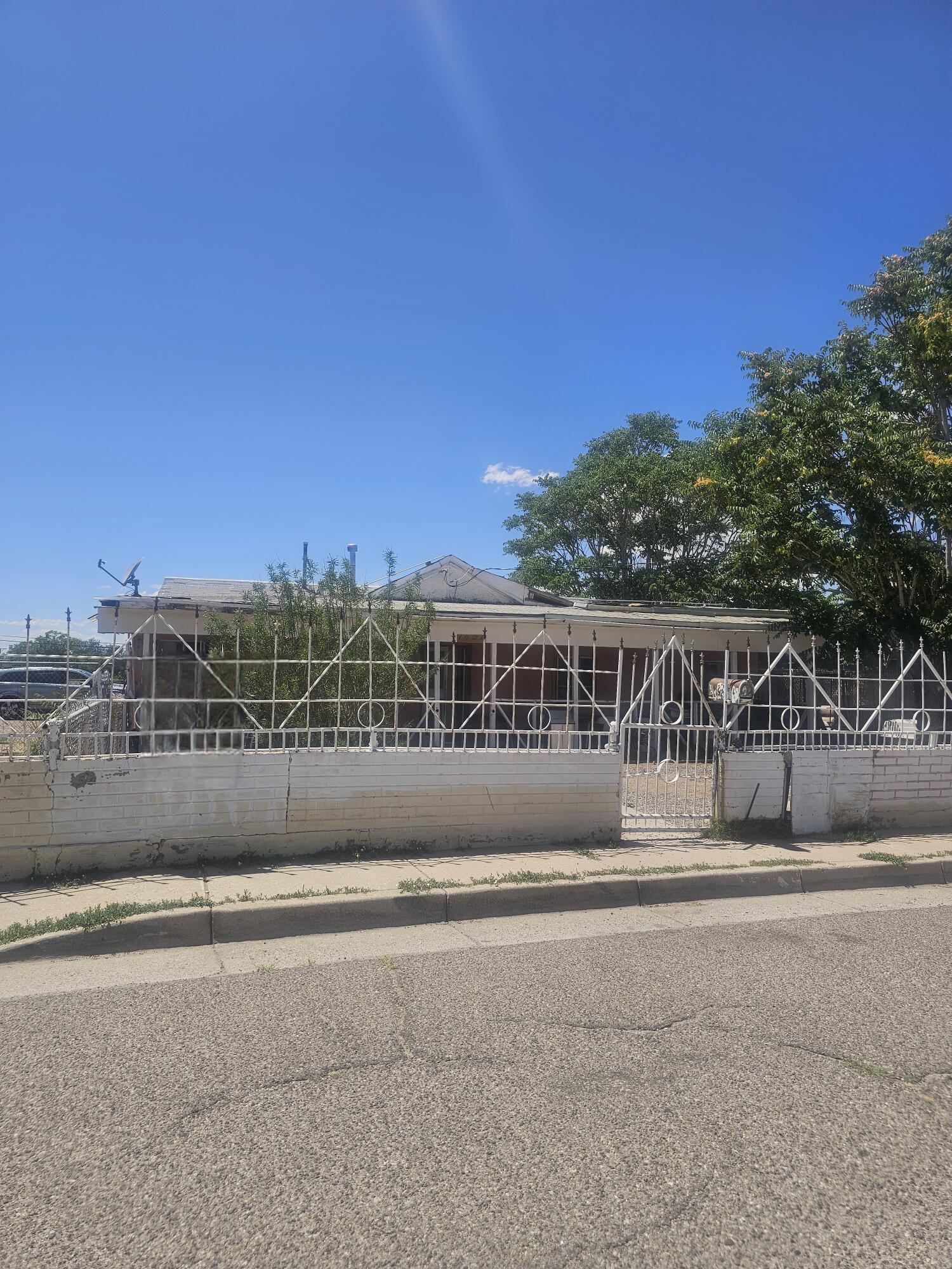 Located in Albuquerque's historic Southeast Heights, 1921 John St SE offers a rare opportunity to own a home that's stood the test of time--five generations strong. This property is filled with character and stories, waiting for the next chapter to be written. While it does need some work, its potential shines through every room and corner.Ideally situated near UNM, CNM, major freeways, the airport, and lively downtown, you'll have access to the best of the city just minutes from your doorstep. Whether you're a renovator with vision or someone who values legacy and location, this home is a canvas for your creativity. Don't miss the chance to restore a piece of Albuquerque history.