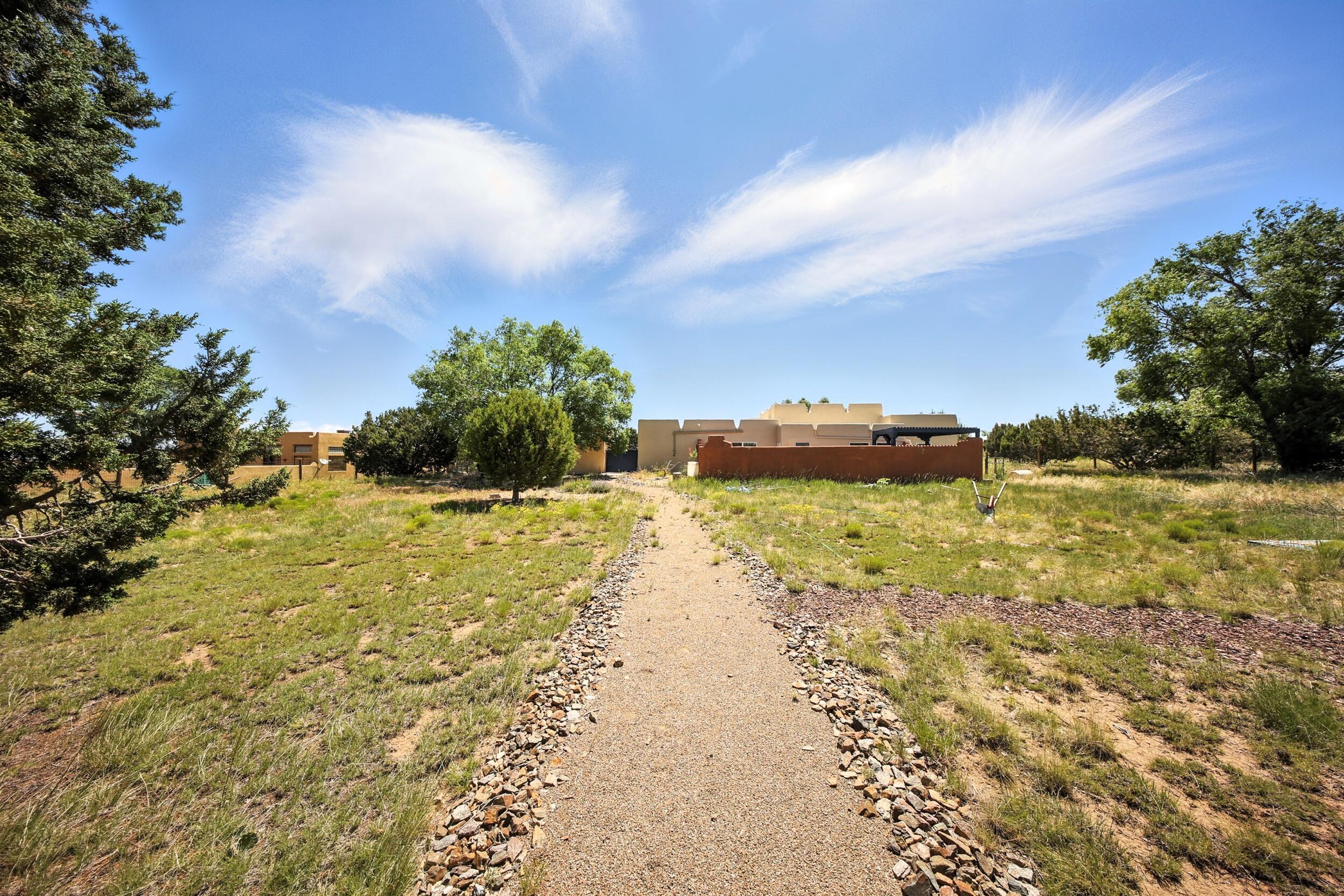 Exceptional Home on 2 Scenic Acres!Enjoy breathtaking views from this beautifully appointed home featuring a spacious great room, stainless steel kitchen, elegant dining area, and cozy sitting room. The split master suite includes a luxurious custom jetted tub and dual walk-in closets. Flexible floorplan with office or 4th bedroom option.Outdoor living at its best with private front and rear courtyards, a charming gazebo, sunroom, and a fully equipped outdoor kitchen. Additional features include a storage/hobby room in the garage, a 10x16 stucco storage building, RV pad, and four 70-gallon rainwater collection tanks.Low-maintenance xeriscaped landscaping front and back, fully fenced rear yard with backyard access!  This stunning property is truly a must-see!