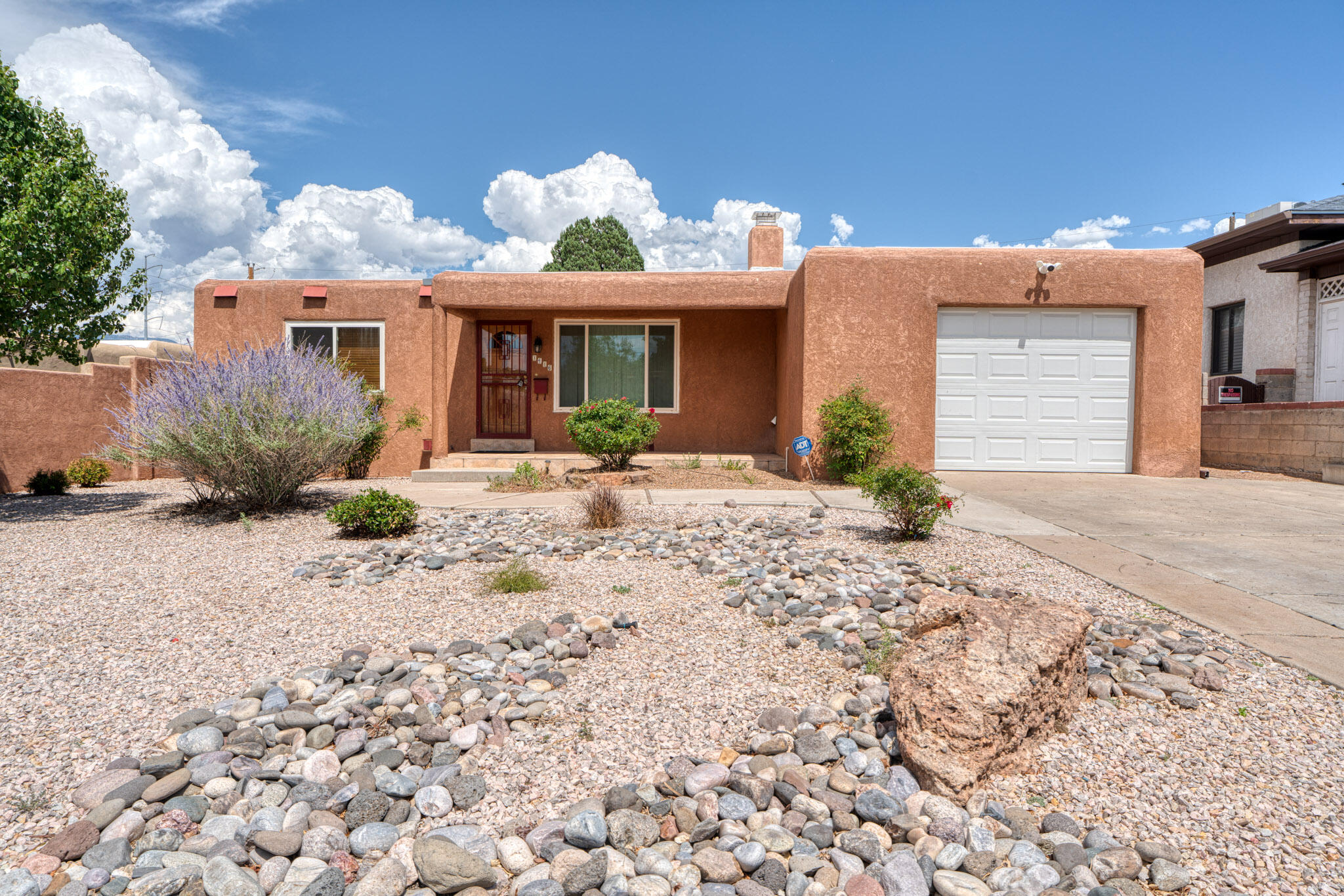 Beautifully cared for home in North UNM area.  Conviently close to shopping,  dining, gyms & interstate access. Home features many well cared for original details incl. gorgeous narrow strip wood floors, niche, built in linen, plaster & stacked block fireplace and lovingly maintained period tile in baths. The kitchen has been updated to with shaker maple cabinets, tile backsplash & deep stainless sink with mountain views.  Added bonus of newer systems across the board incl, newer hot water heater, furnace, REFRIDGERATED air, windows, stucco, electric panel & a brand new (7/25) TPO roof w/warranty. Also included OWNED SOLAR. Home is fully landscaped front & back with cloud based controls on drip/sprinkler system.  Extra storage in garage storage cabinets & shed. Move in & relax, hurry!