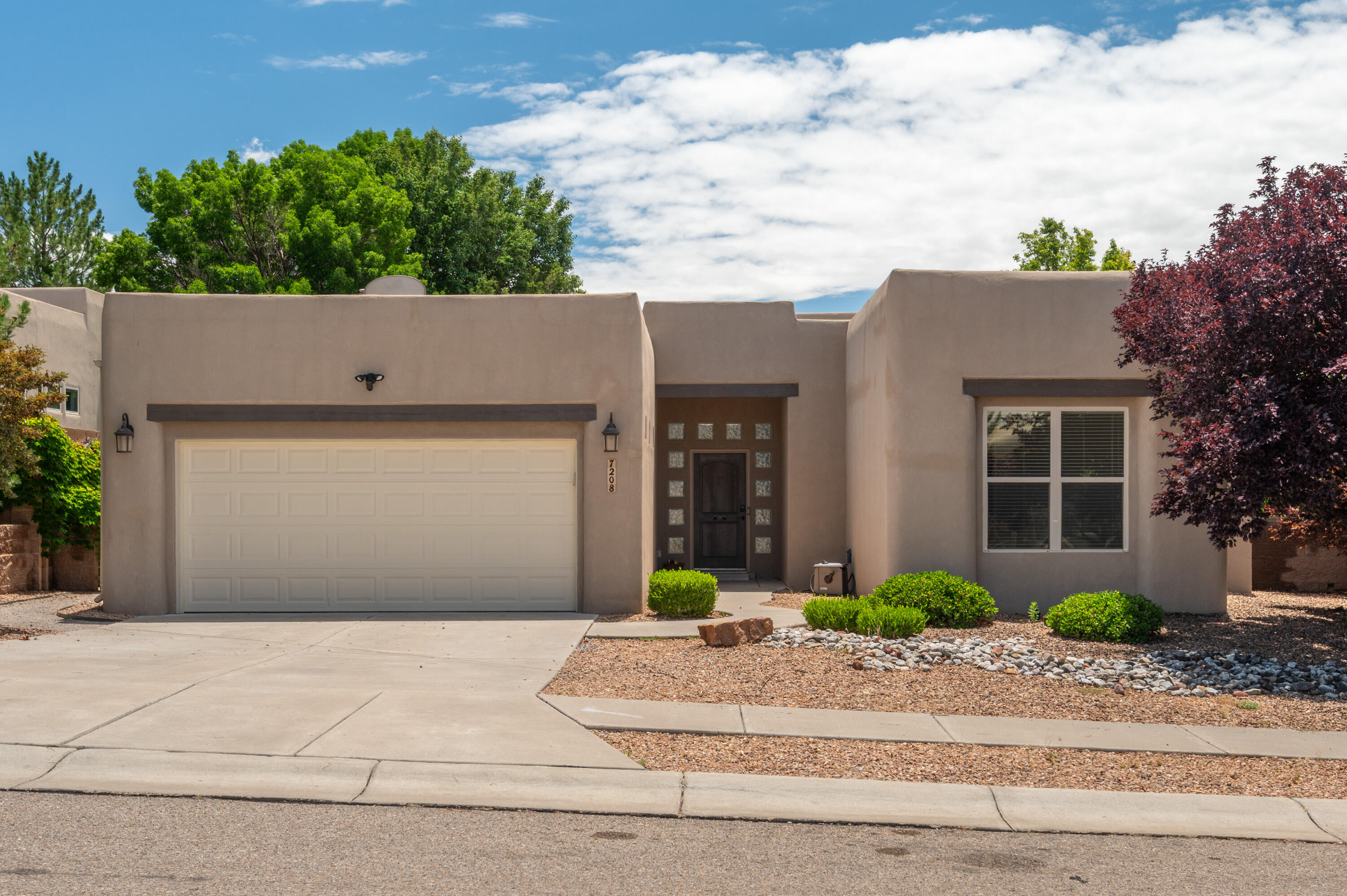 Absolutely exquisite! This rare find boasts a 4-bedroom, single-level home nestled in the highly sought-after Desert Ridge Trails subdivision. The interior features numerous updates, including elegant grey plank wood tile in the hallway and kitchen/dining area, a beautifully updated hall bath with dual vanity sinks, modern light fixtures, and a refreshed shower/tub surround. The spacious kitchen seamlessly flows into the inviting great room and dining area, offering a center island, stainless steel appliances, a corner pantry, and a charming breakfast nook. The great room exudes warmth with its wood beams, vigas, fireplace, and captivating curvilinear wall. Step outside to the stunning backyard, ideal for entertaining with its lush trees creating a natural canopy for relaxing evenings.