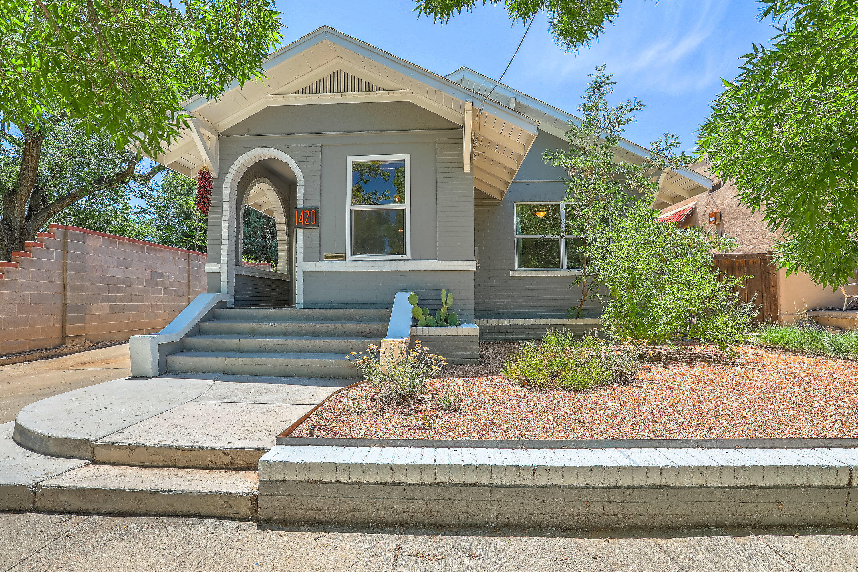 Live in history among the mature growth trees in the Historic Fourth Ward neighborhood of Downtown Albuquerque!The warmth and old world charm of the living room and study will leave you at peace the moment you arrive through your front door. A lovingly updated primary bedroom suite will make it hard to want to leave. The best part is heading to your resort-style back yard straight from the bedroom, complete with a sauna, custom-built water feature, lush foliage and a sunny patio.Stroll to Mary Fox Park in seconds, and the heart of Old Town, Downtown, and the Sawmill District within minutes. A quick bike ride gets you onto miles of trails through the Rio Grande Bosque.This home will capture your hearts as soon as you see it in person.