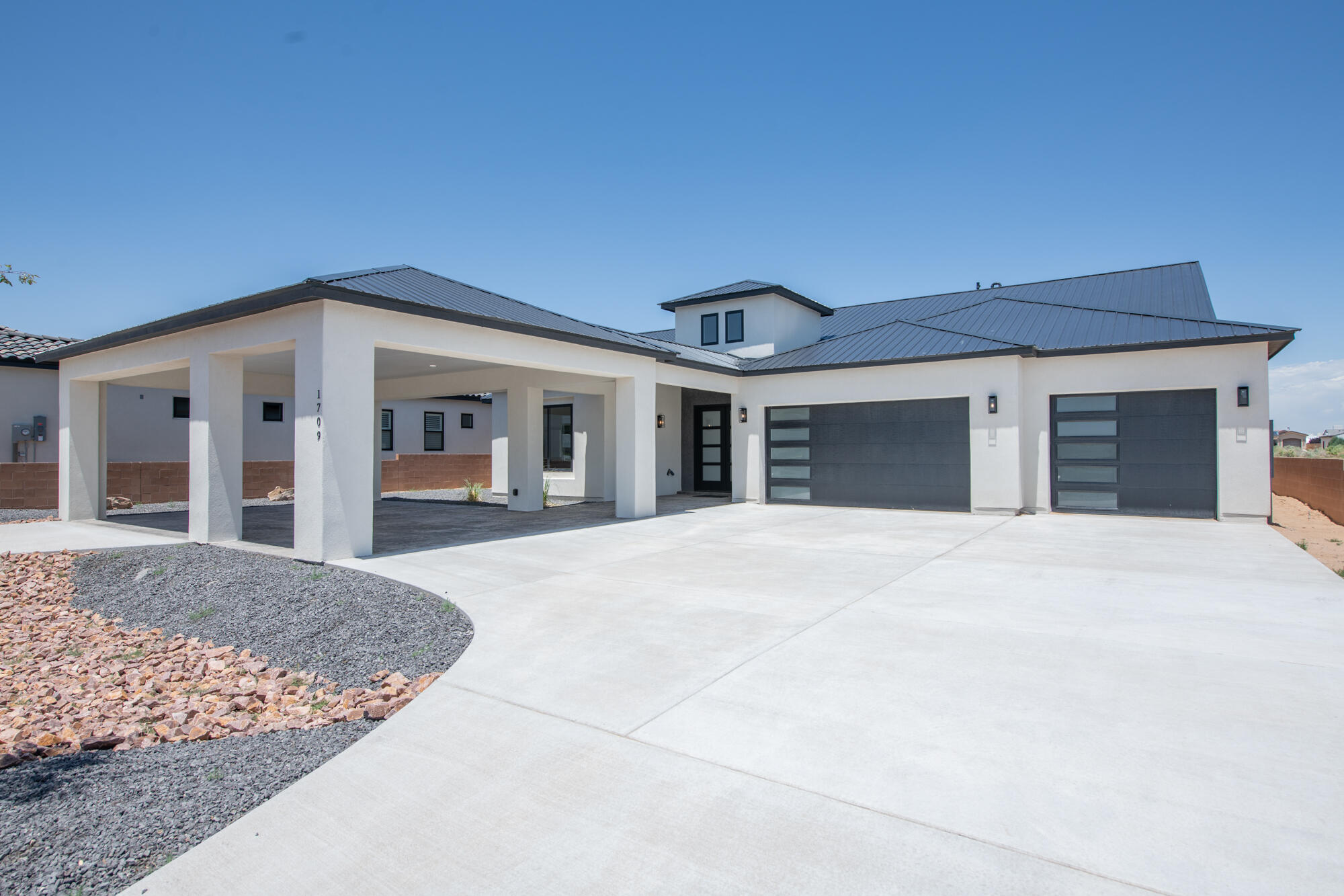 Stunning brand new construction luxury home nestled in the Rio Rancho Estates subdivision. This 5 bedroom, 3 bathroom masterpiece is located on a half acre lot with amazing views of the Sandia mountains. Featuring an expansive open floor plan, the home's architectural centerpiece is a sleek, contemporary gas fireplace that anchors the living space with understated elegance. A gourmet kitchen featuring top-of-the-line appliances and a spacious walk-in pantry, this kitchen is designed for both serious cooking and elegant entertaining.Abundant natural light cascades through the interiors. The primary suite is a true sanctuary, featuring a luxurious en-suite bathroom that leads to an impressive walk-in closet. Custom built-ins and an elegant vanity area. Schedule your showing today!