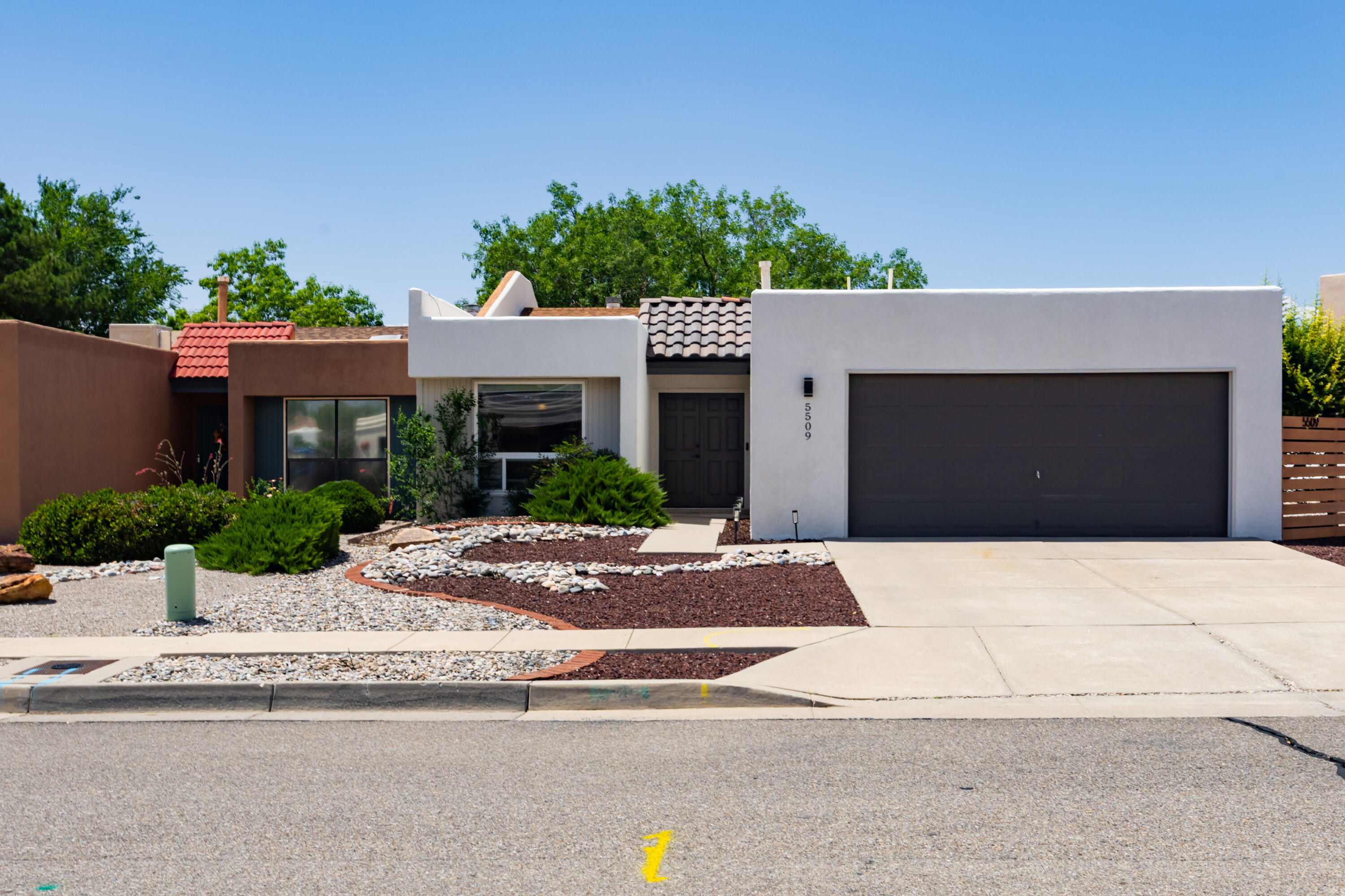 Fall in love with this beautifully updated single level home, located in a prime far NE Heights location, just a block from the Academy Hills Park,  grocery shopping, and restaurants! Step inside to an open and bright floor plan enhanced with cathedral ceiling, recent plank flooring & carpet! Delightful kitchen offers stainless steel appliance, granite counter tops, lovely white cabinets and cozy breakfast nook! New refrigerated air conditioner! Gorgeous re-done landscaped backyard with towering shades trees, flower beds, covered & open patios, deck; a serene space with total privacy! Remodeled bathrooms, & master bedroom with large en-suite bathroom, offering 2 vanities with granite counter tops, & separate shower & tub! Large 2 car finished garage completes this fabulous home! Must see!