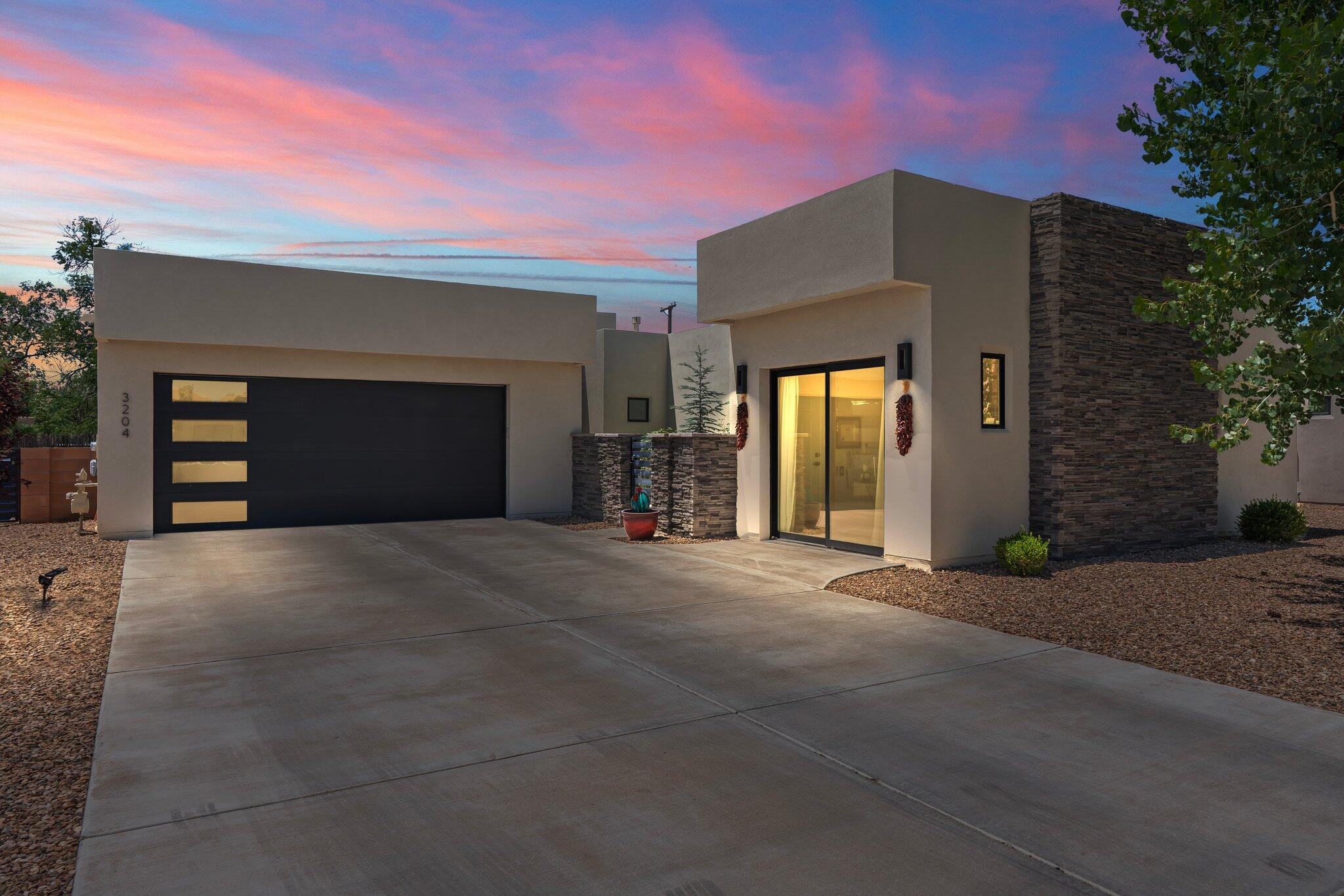Immaculate one story custom luxury home nestled in the tranquil & prestigious gated area of Bosque Antigua located in the North Valley.  Modern elegance combined w/ energy efficiency (Build Green NM) w/a HERS score under 60!  This former model home is a modern masterpiece seamlessly blending architectural innovation with the natural beauty of its surroundings.  Light bright & open concept  10-12 foot ceilings in Great Room w/Frplc, Kitchen & Dining. Gas cooktop (Bosch) SS appliances, quartz countertops  incredible Primary Suite, w/ huge walk in closet.  Two Bedrms, w stunning adjoining ensuites, which are located opposite of Primary suite.  Bonus feature is a heated & cooled detached studio ( w/ plumbing available) included in sq. footage which can  bedroom, office or studio.