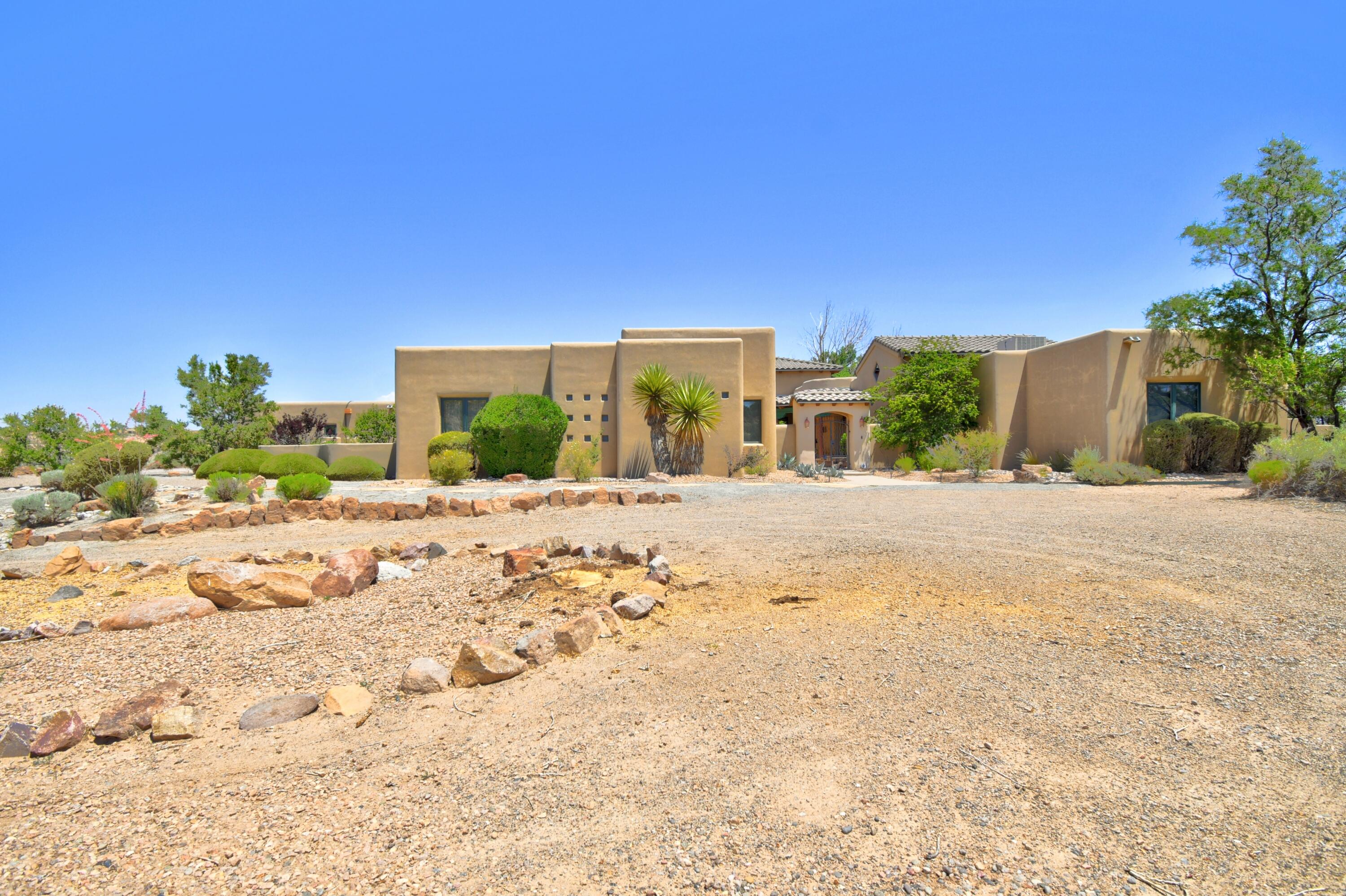 Custom built by Lancor, this Tuscan style former Parade of Homes model sits on 2.9 acres with endless mountain views! Spanning 4,135 sq.ft., it offers 4 bedrooms, 3 baths, and a living room with a custom fireplace a wet bar. The secluded Owners Suite features a kiva fireplace, private office, and entrance. You'll enjoy the gourmet kitchen with granite counters, Sub-Zero fridge and Dacor appliances. The formal dining room with fireplace is perfect for gatherings. Beautiful vaulted tongue & groove ceilings flow throughout the home. The In-Law Suite, hobby room, and media/gym room each have private entrances. Enjoy the tranquil courtyard with water feature and rooftop deck. The oversized 3-car garage and RV pad is large enough for all your toys. There's so much more! Don't wait, see it today
