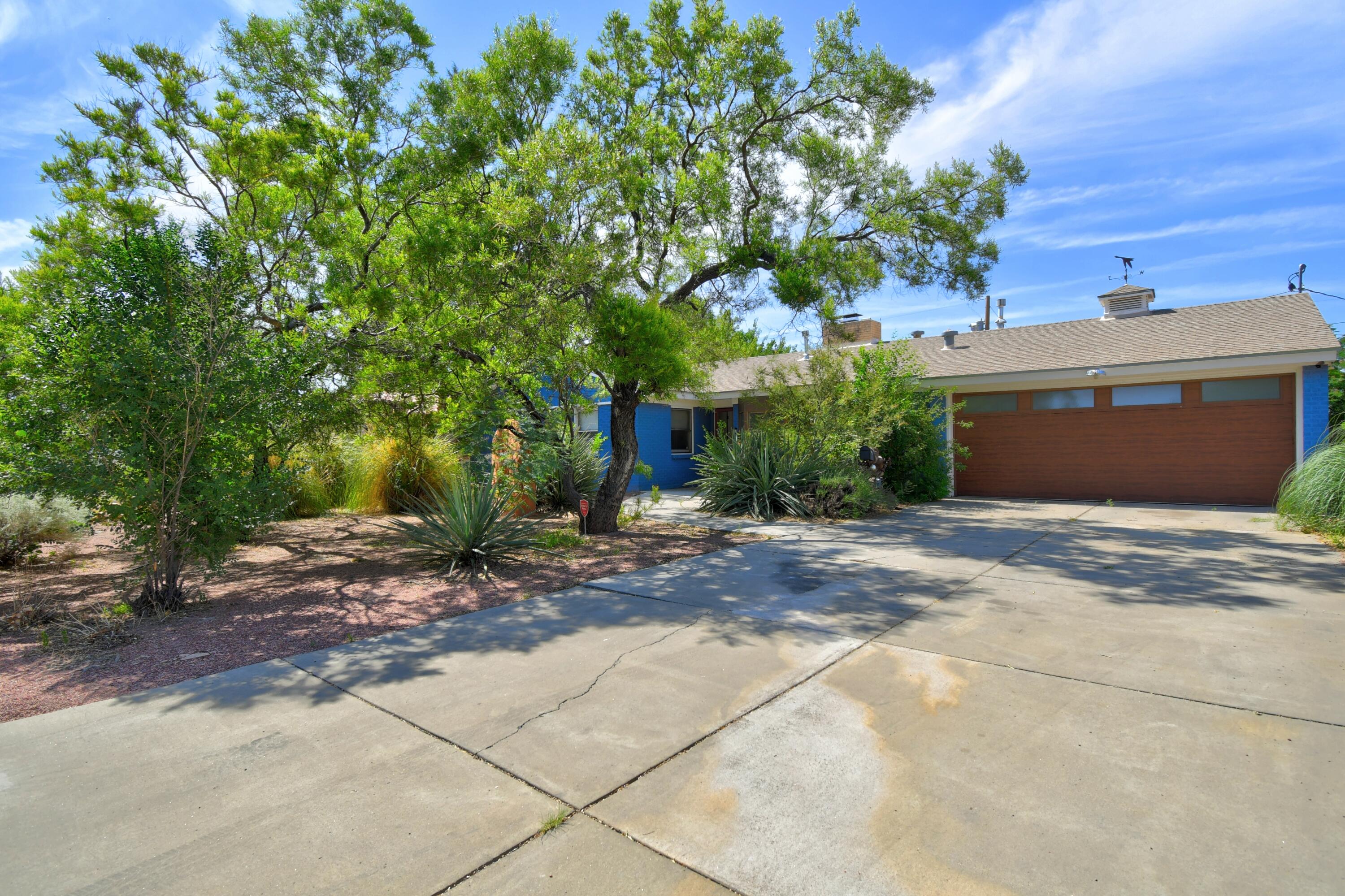 The Blue house- is a lovely Brick home in the Albuquerque Country Club. Pitched Roof, Refrigerated Air, Remodeled with a large Primary Room, and large Primary Bath, Steam shower and jetted tub. New carpet installed in 7/2025 in bedrooms, Lovely engineered hard wood in the living spaces.  Bright and cheerful kitchen, new refrigerator 7/15, lots of windows and light throughout the home.  Two large fireplaces, one in the dining room. Large back yard.  Great Floor plan come see it today.