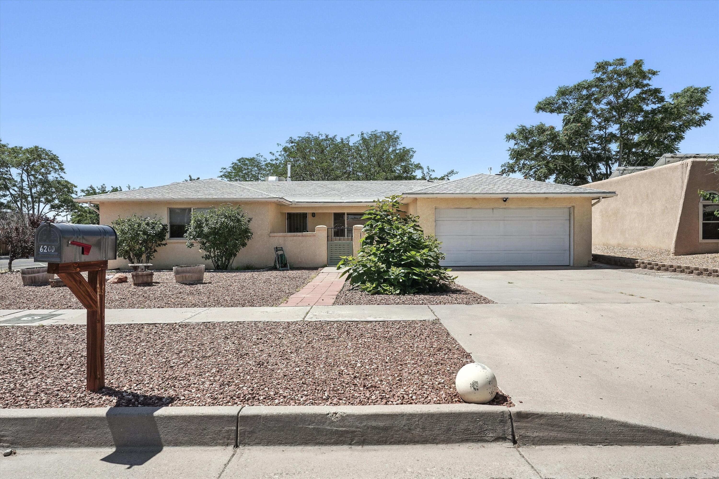 Welcome to this charming North West Albuquerque gem located in Taylor Ranch! This single story home offers 3 bedrooms, 2 bathrooms, and a 2 car garage. The layout features two living areas. One includes a wet bar and a beautiful travertine fireplace that would make a great space for relaxing or entertaining. Tile floors throughout the home make maintenance easy, plus brand new carpeting in the bedrooms and den area. Updated kitchen includes stainless steel appliances, beautiful backsplash and touches of custom craftsmanship. Updated full size guest bathroom and a separate laundry room for convenience. Enjoy the oversized corner lot with side gate access. This private backyard includes a gated gardening area and a covered patio. Close to parks, library,grocery shopping, and restaurants.