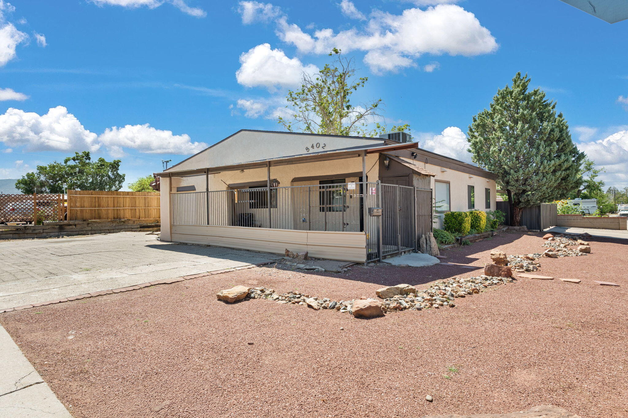 Welcome to this upgraded home located in one of Uptown ABQ's most convenient and desirable areas! Inside, you'll find tile flooring, plush new carpet, and the comfort of refrigerated air. Even better, this home comes equipped with PAID OFF solar panels and a paid off water softener system, giving you both energy efficiency and peace of mind.The kitchen features butcher block countertops and stainless steel appliances. Enjoy the flexibility of two spacious living areas, two dining spaces, or convert one into a 4th bedroom or home office to suit your lifestyle.Step outside to two workshop rooms for hobbies or extra storage, a covered parking area, and a large side gate for easy backyard access. Don't miss your chance to make this yours!