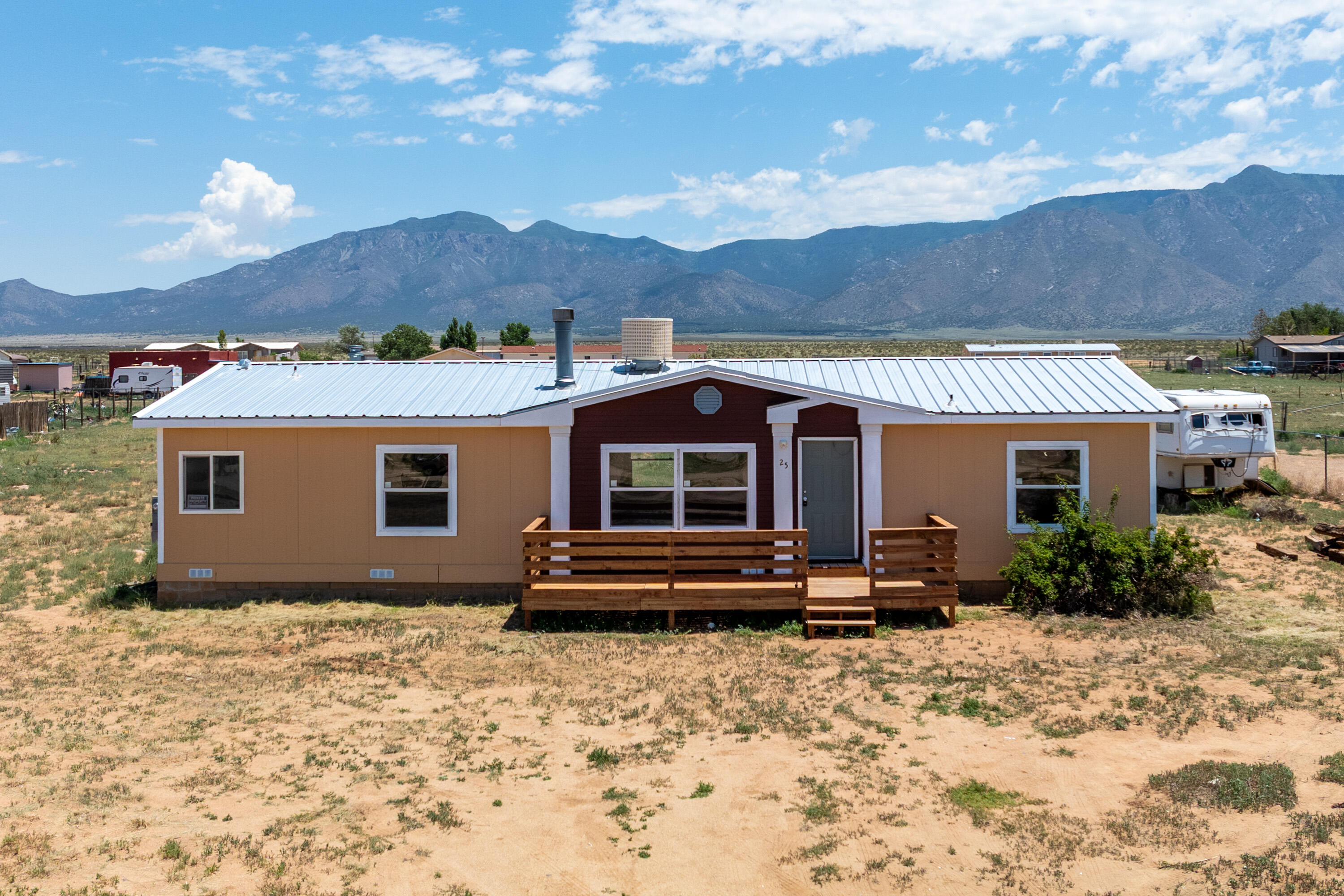 This Manufactured home has undergone a complete remodel including the roof, interior flooring, appliances, painting inside and outside, new front porch, and so much more.  Views from both east windows and West side.  Upgraded electrical box 100 amp panel, new Propanel roof, Great size lot for all your toys.