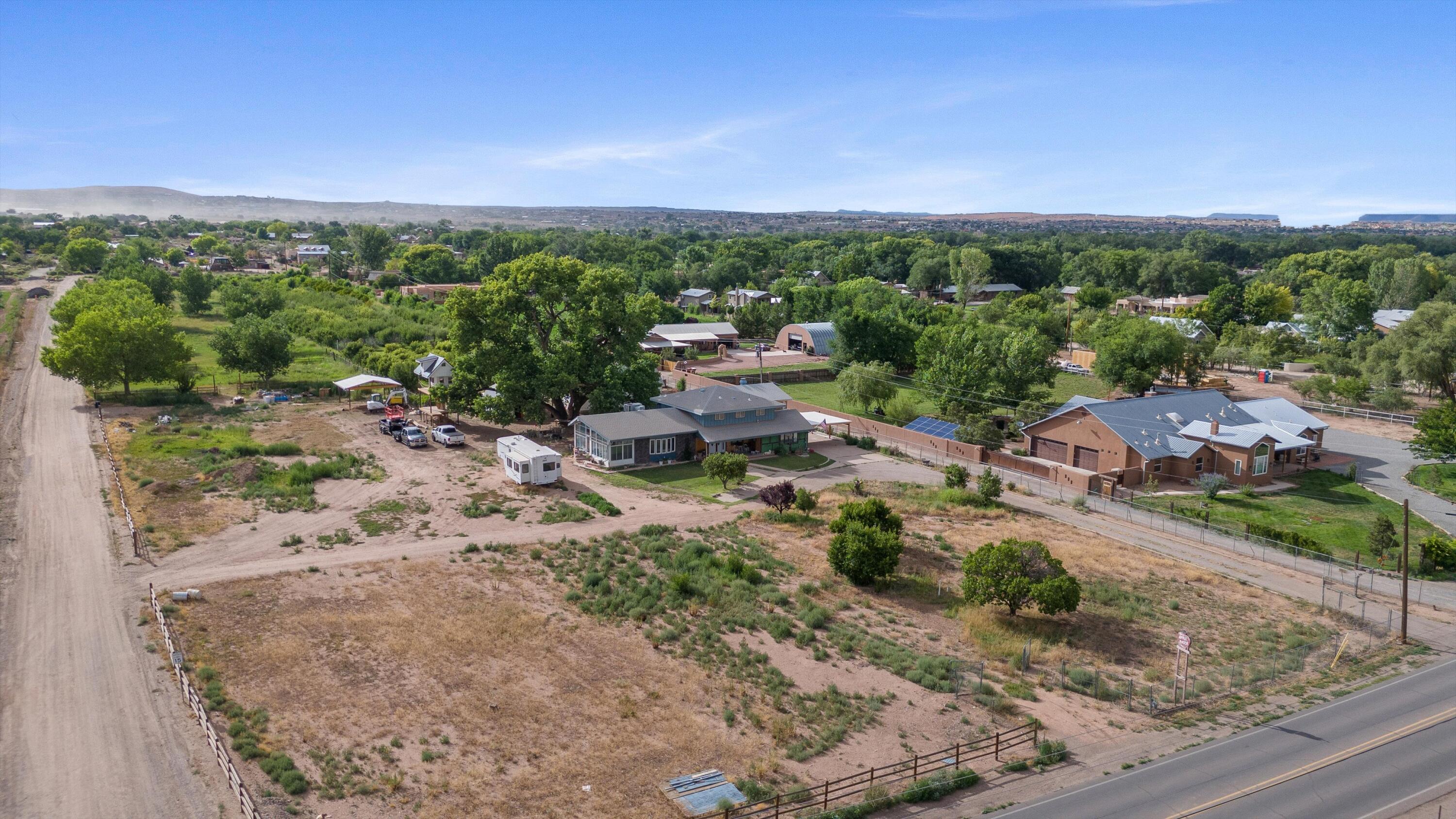 Large Two Parcel Sale!Parcel 1: Main House and Lot (3.91 Acres)Discover a unique opportunity in the heart of Corrales, with this property featuring a charming main house brimming with potential. The main level features a few updates with ample room for personalization, allowing you to create your dream home. An unfinished upstairs awaits your creative vision, perfect for customizing to your taste. The 722-square-foot finished basement provides additional living space, ideal for a home theater, office, or recreation area. Outside, a one-of-a-kind, three-level tree house--potentially the tallest and most spectacular in Corrales--adds a whimsical touch for family fun or unique entertaining. The north side of the lot boasts an orchard with over 300 fruit trees, including