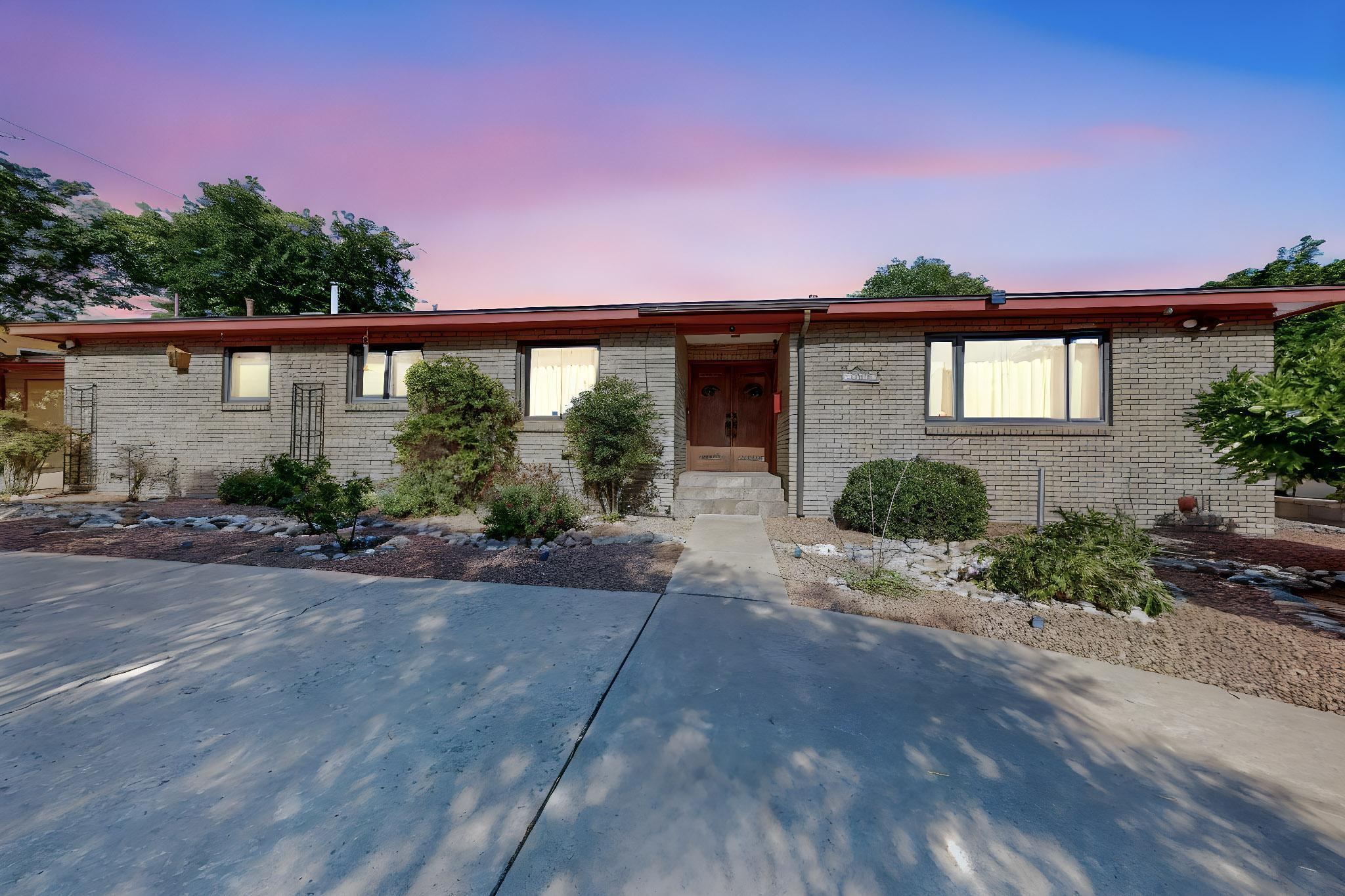 Gorgeous, tasteful remodel in UNM north. Excellent floor plan w/blond hardwood floors, beautiful ceramic tile, a kitchen remodel to die for! Slab granite counter tops, completely refurbished & refinished cabs, top-o-the line SS appliances, more. 2 large living areas, formal & informal dining to seat 10 or 12, fireplace, wet bar, den w/great light, access to very private backyard w/large patio, and water feature. Bedrooms are nice sizes w/good closets, baths reworked perfectly! Hi-end windows, Tankless water heater, RO water system and Kentico water softner. Rooftop solar keep bills at a minimum, and is owned out right! This is a must see and a must have home. The Back yard is a retreat in the middle of the city.