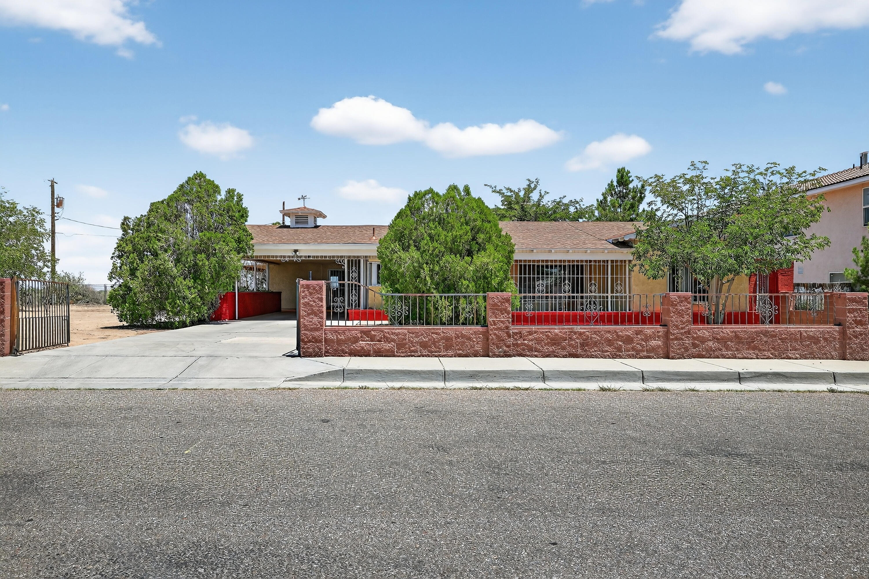Custom home in Crestview Bluff with amazing views of Sandia Mountains, downtown Albuquerque, and the Bosque.   Spacious floorplan works well for multi-generational living or income potential as a duplex-style investment.  Separate entrances, 2 kitchens, 2 laundry rooms and 2 living rooms.  Updated sewer, electrical, plumbing, roof and windows.  Features built-in desk, office area, indoor grill, beamed ceiling, skylight, wine cooler, stainless steel appliances, laundry sink, 2 fireplaces, covered porch, 2 covered patios, fully fenced, & attached exterior storage room. Original home has central forced gas heating and refrigerated air.  Addition has mini-split and wall unit.  One-acre lot east of property to be purchased for additional $40,000.  See MLS #1087786.  Convenient access to I-40
