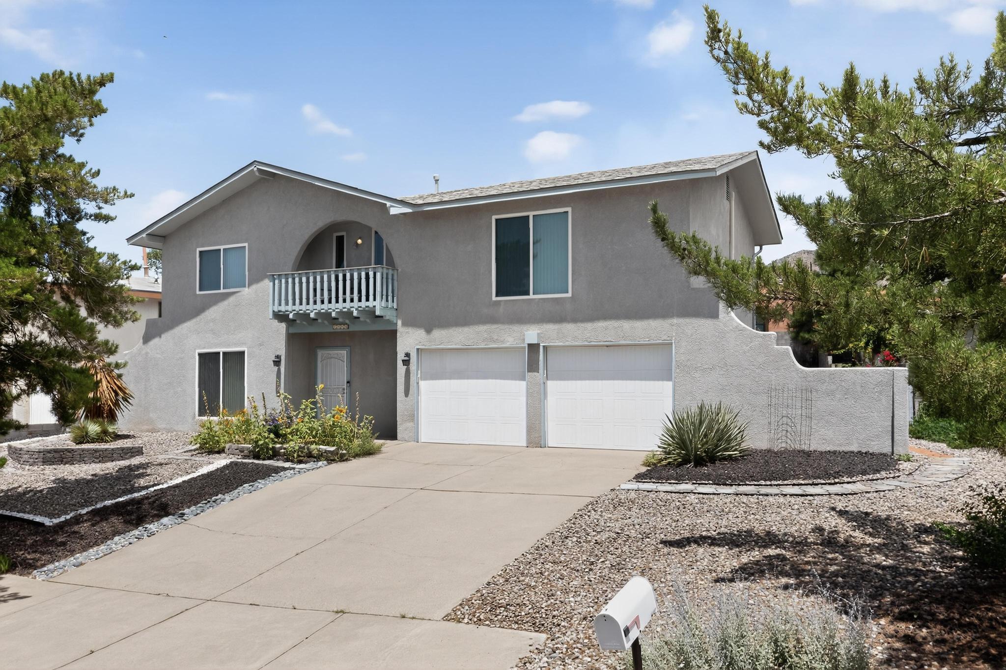 This beautiful 2-story home has four bedrooms and three baths. It spans an attractive 2400 sq feet floor plan and is a stone throw away from foothill and mountain trails. You will enjoy city views to the south and west from the front balcony and the second floor. Much of the property also has views of the Sandia mountains, but especially the spacious second floor deck. Underneath the deck is covered patio with a spiral staircase taking you between them. The house presents lovely hardwood and tile floors throughout. Just inside the front door you stand in the entryway with high ceilings and stained glass windows. Comfort and elegance come from many updates that include a granite themed kitchen, floor to ceiling tiled bathrooms, marble fireplace, and refrigerated air conditioning.