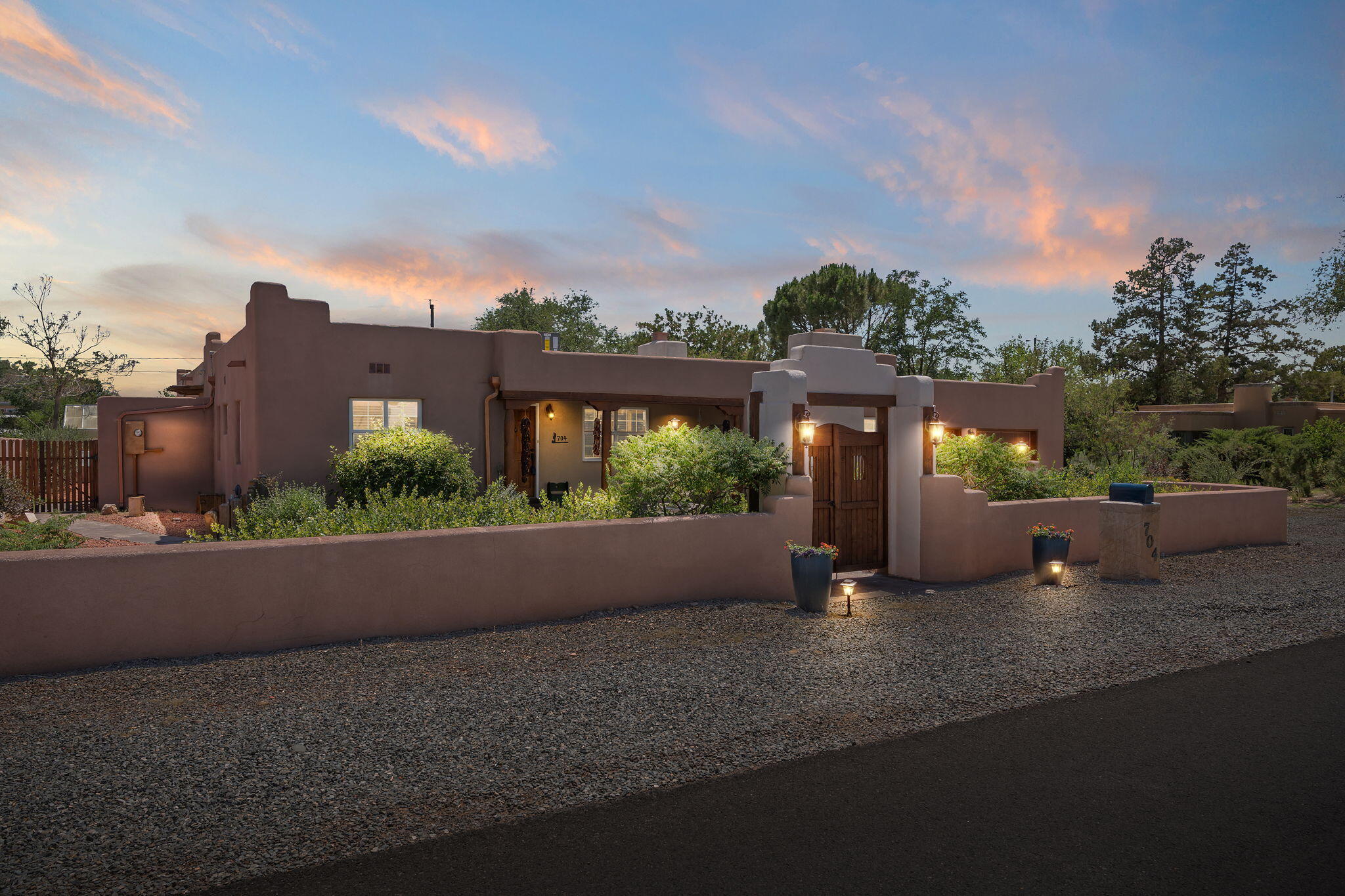 The SW charm of this 4BD/4BA exquisite custom home in the heart of Los Ranchos is unrivaled. Featuring 4 beautiful fireplaces, the more than 4,000 sq ft of living space provides unlimited versatility for in-law quarters, office space, etc.  An interior wet bar & numerous doors leading out to the courtyard & outdoor kitchen make this home a true dream for entertaining. The formal dining room is conveniently serviced by the adjacent kitchen featuring a perfectly located pass-thru. The massive primary BR/BA is 943sq/ft of resort-like luxury. The main family room is giant at 735 sq/ft. No expense was spared in appointing this stunningly spacious home with beautiful hardwood floors, arched doors/doorways and stunning architectural wood ceilings. Just minutes from fine dining and shopping.