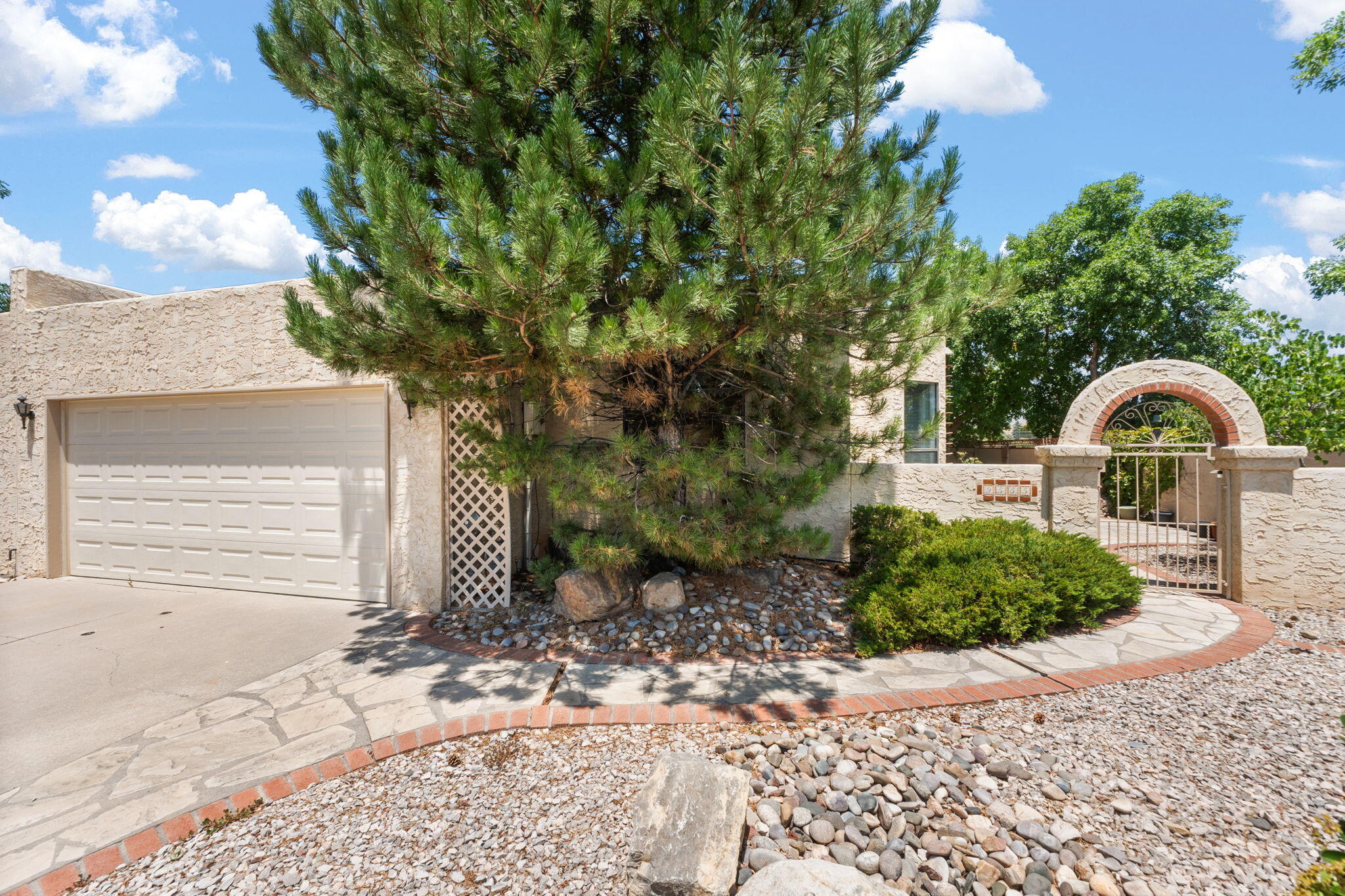 Enjoy stunning Sandia Mountain views in this lovely 3-bedroom, 3-bathroom townhome, ideally located just steps from walking/biking trails and Quintessence Park. The light-filled, open-concept living area showcases high ceilings, a warm fireplace, and an expansive dining space perfect for both relaxing and entertaining. The kitchen features a breakfast nook, ample cabinetry, and a walk-in pantry. The main-level primary suite offers a peaceful space with its own sitting area, oversized walk-in closet, and a spacious ensuite bath with dual vanities, soaking tub, separate shower, and direct access to a private patio. A second bedroom and nearby 3/4 bath complete the main floor for added convenience. Upstairs is the 3rd bedroom, bathroom, another living space, a study, and a deck with VIEWS!