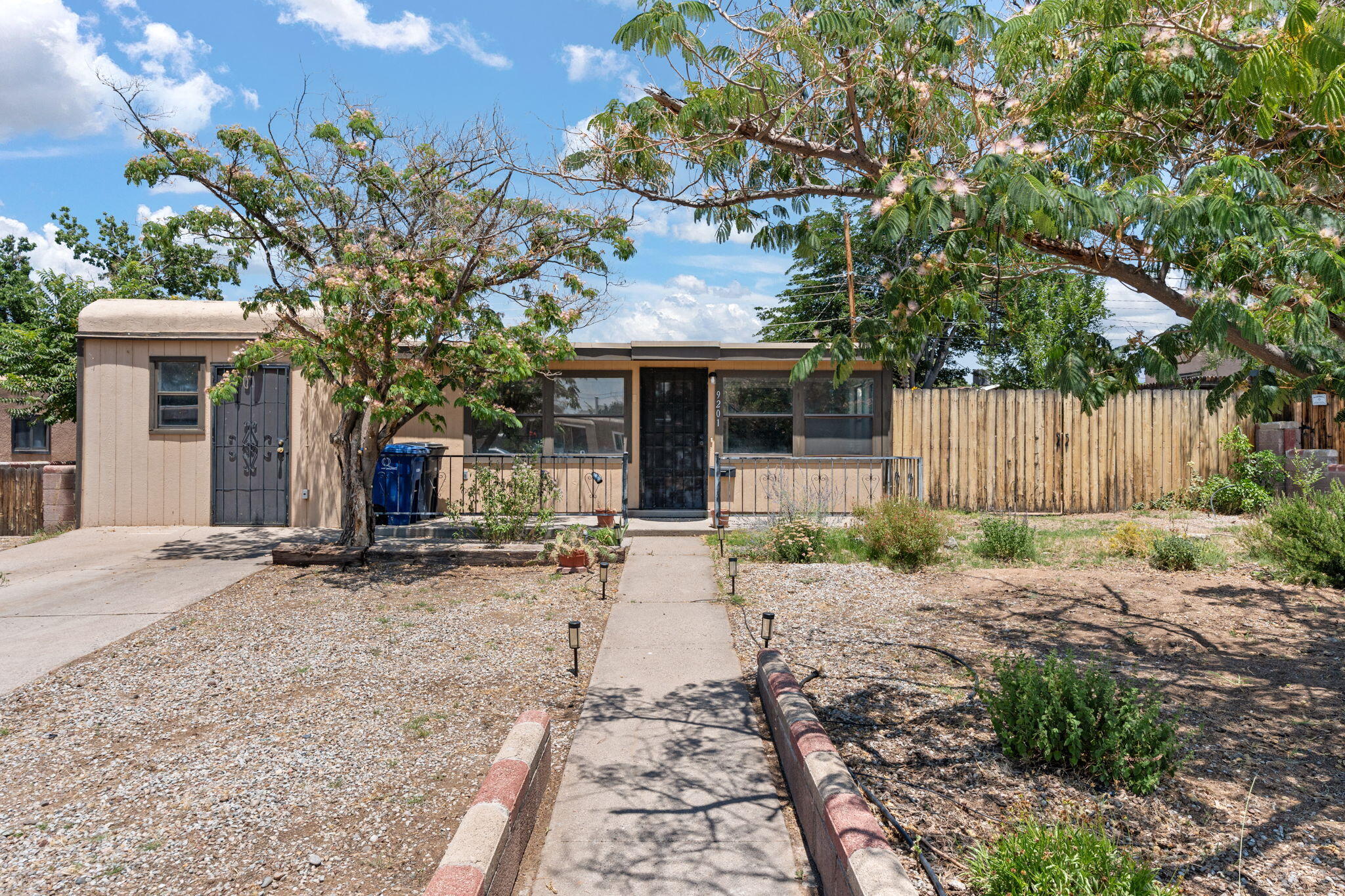 Move-in ready NE Heights gem! This 4-bedroom, 1.5-bath home offers a refaced Kiva-style wood-burning fireplace. Enjoy two spacious living areas perfect for entertaining or relaxing. The converted garage serves as a 4th bedroom with its own private entrance--ideal for guest space, in-law quarters, or office. The kitchen provides ample space and opens to a dining area, great for daily meals and gatherings. Outside, a large backyard awaits your personal touch, complete with side yard access and extra storage. Centrally located near shopping, schools, and parks. Don't miss this opportunity--schedule your showing today!