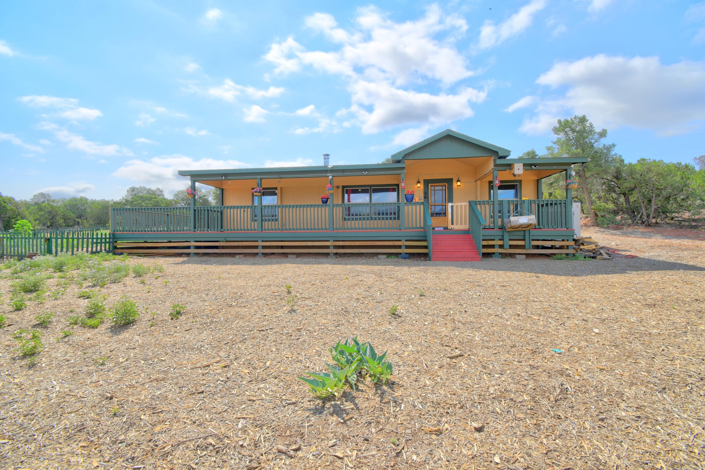 Welcome to your new home on this lovely 5-acre lot! This cozy 3-bedroom, 2-full-bath home is perfect for those seeking space, sitting on a generous 5 acres with beautiful views all around. Freshly painted and move-in ready, the home features no carpet for easy maintenance and a charming wood stove for those chilly evenings. The primary room boasts a spacious walk-in closet, while the kitchen island is ideal for gatherings. Enjoy the convenience of a private well anda fully fenced side yard. Plus, a storage shed provides ample space for all your tools and outdoor gear. With a pre-inspection already done and some repairs completed, this property is waiting for you!