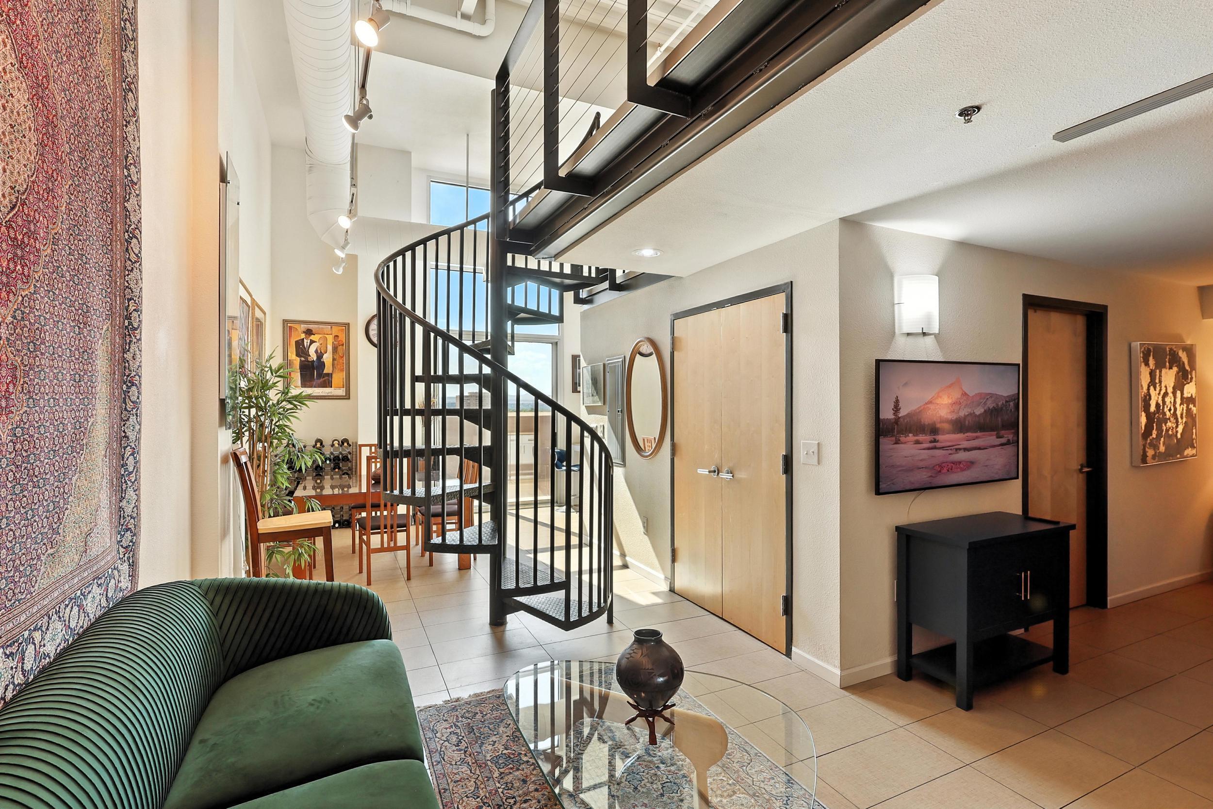 Luxury loft-style living awaits in this 8th-floor condo in the Anasazi Building, featuring soaring ceilings, abundant natural light, and modern style. The open layout flows seamlessly to a west-facing balcony--perfect for sunset views over the city. Enjoy dedicated parking in a secured garage and a prime location that is just steps from Albuquerque's best nightlife, restaurants, galleries, and theaters. Ideal for anyone looking to live in the heart of it all.