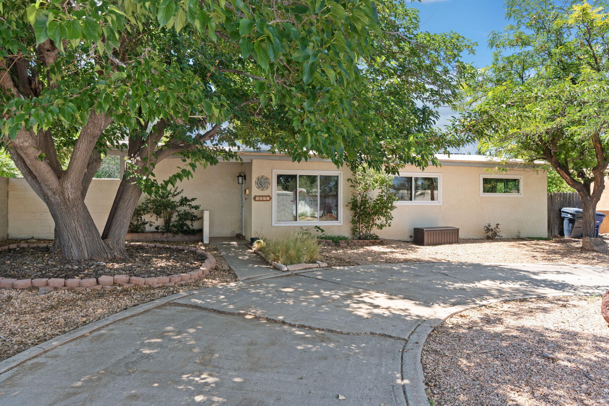 Don't miss this adorable house in the heart of the NE Heights!  Gorgeous wood beam ceilings, updated flooring, new windows, and separate primary suite make this cozy house a charming place to call home.  Beautiful backyard oasis is a perfect spot for entertaining guests or enjoying a quiet morning.  Lots of upgrades including updated bathrooms, a backyard greenhouse, and water softener. As an added bonus, this home includes solar that will be paid off at closing!