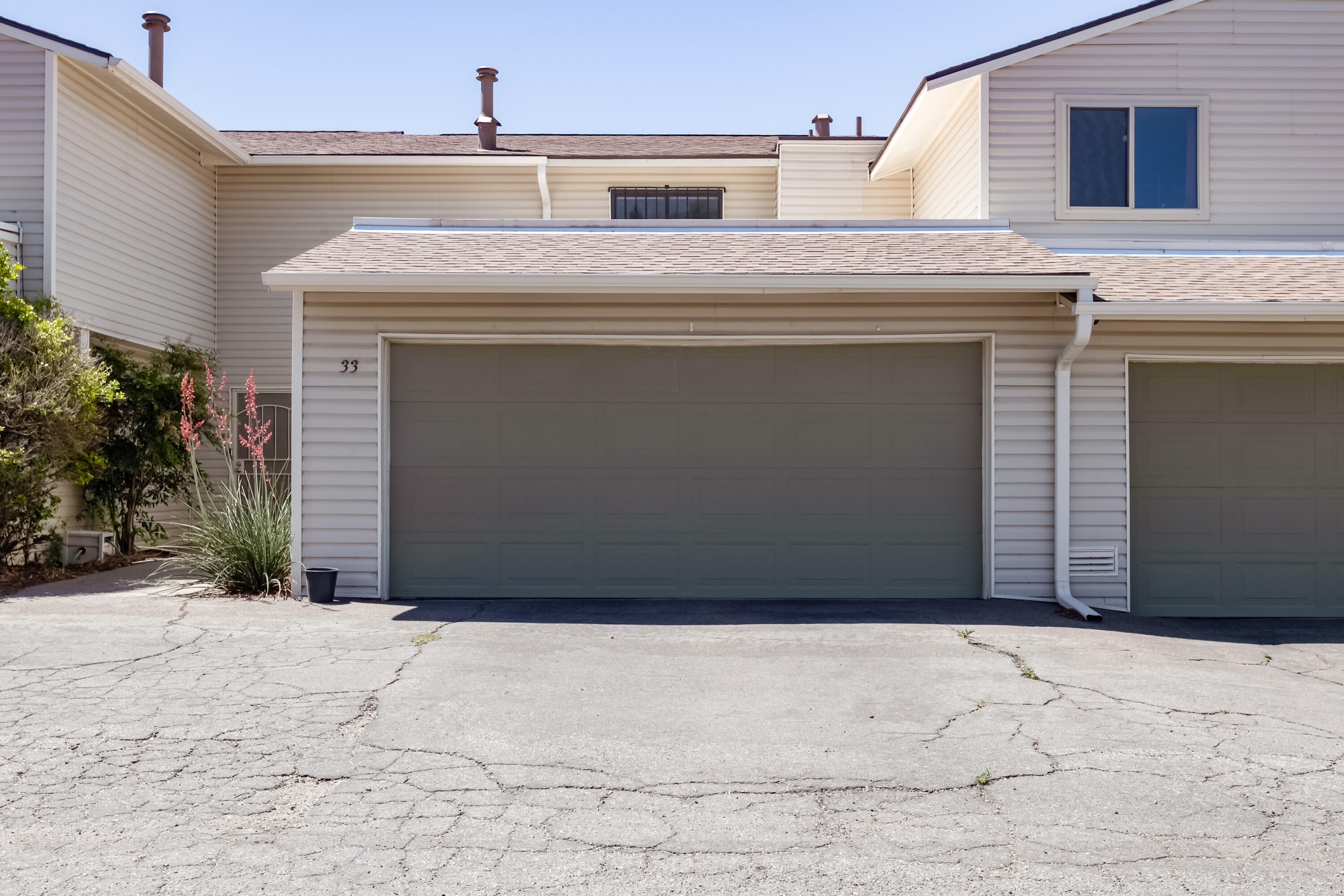 The Shores townhome community provides for an convenient lifestyle with pool, tennis courts, common area and clubhouse. This community is perfect for low maintenance--HOA covers the exterior of the residence (roof and siding) plus the sewer line, trash/water/sewer, and exterior insurance. This is an adorable  property in great condition! Newly added laminate wood floors in the living and dining areas. Great open concept with cozy wood burning stacked stone fireplace, dining area w/ bar seating at the kitchen peninsula. Ample cabinet and counter space, pretty backsplash, & SS electric stove & microwave. 2 large bedrooms upstairs, the primary room has a great walk-in closet. Nice updates to the bathrooms. Great sunroom and charming yard with gate to common area. 2 car garage and AC! A gem!