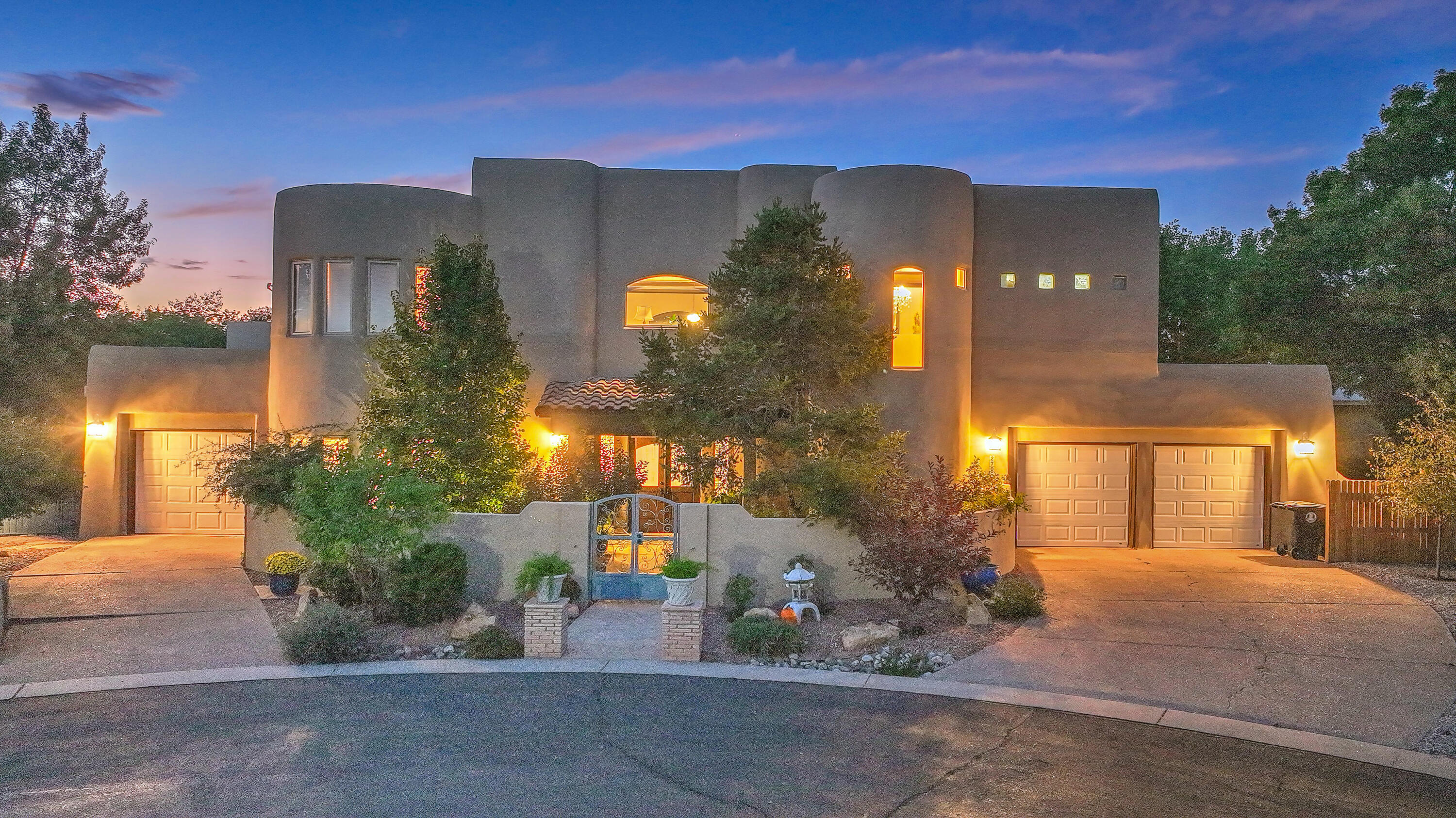 A wonderful place to call home! Located in the North Valley in a quiet, private gated community at the end of a cul-de-sac. The home features 4 bedrooms and 4 bathrooms, a beautiful chef's kitchen with stainless steel appliances and a generously sized media room. The master bath is a lovely place to unwind featuring a beautiful stand alone bathtub , fireplace and a large shower. Off of the master bedroom is a charming balcony to watch the sun set. Lush front courtyard and large backyard portal perfect for entertaining. Home is close to peaceful walking trails and the Rio Grande Nature Center.