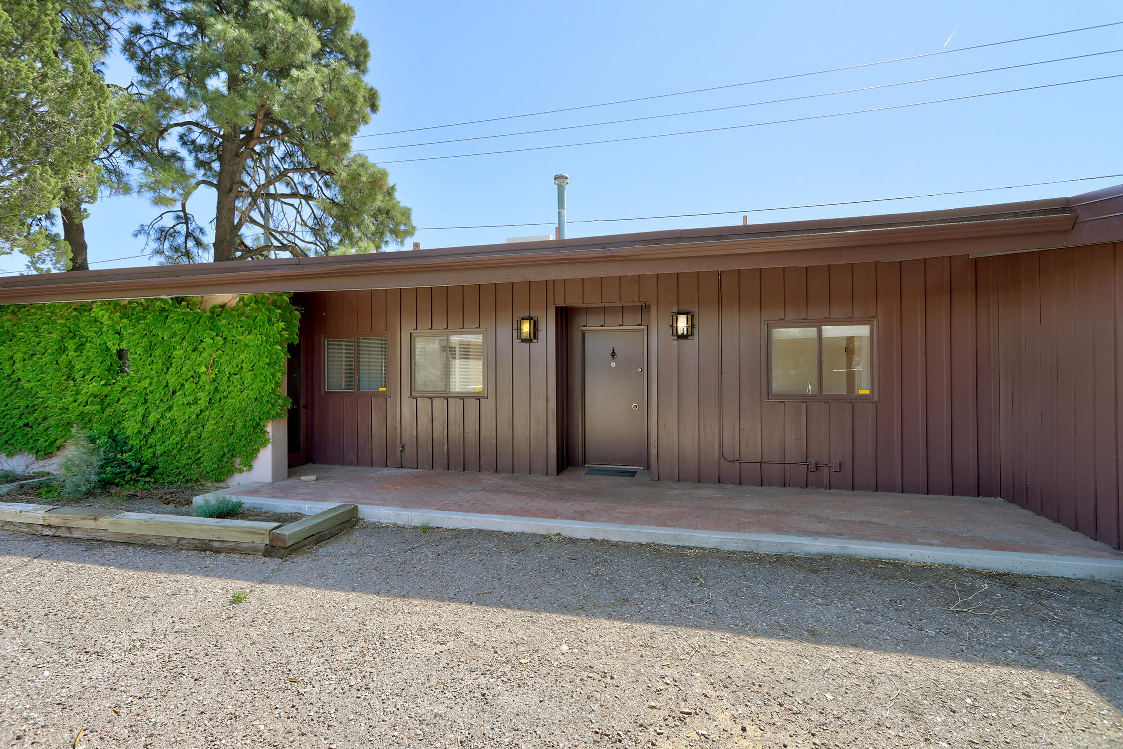 Charming Home for Sale Just Steps from the University of NM. Your Ideal Blend of Comfort, Convenience, and Campus Life Awaits.  Nestled in a vibrant neighborhood just a stone's throw from the university campus, this delightful residence offers the rare combination of comfort and unbeatable location. Whether you're a student, faculty member, investor, or simply someone who values the energy and amenities of university living, this home provides everything you need to thrive. Large family room with cozy fireplace, brick floors & beautiful wood cathedral ceilings.  3 large bedrooms, 1 3/4 Bath, large formal dining room. Primary bedroom has a separate entrance.  TPO Roof, newer water heater in 2023.  No carpet. Stunning Raised cathedral wood beam ceilings throughout the home. Come see today