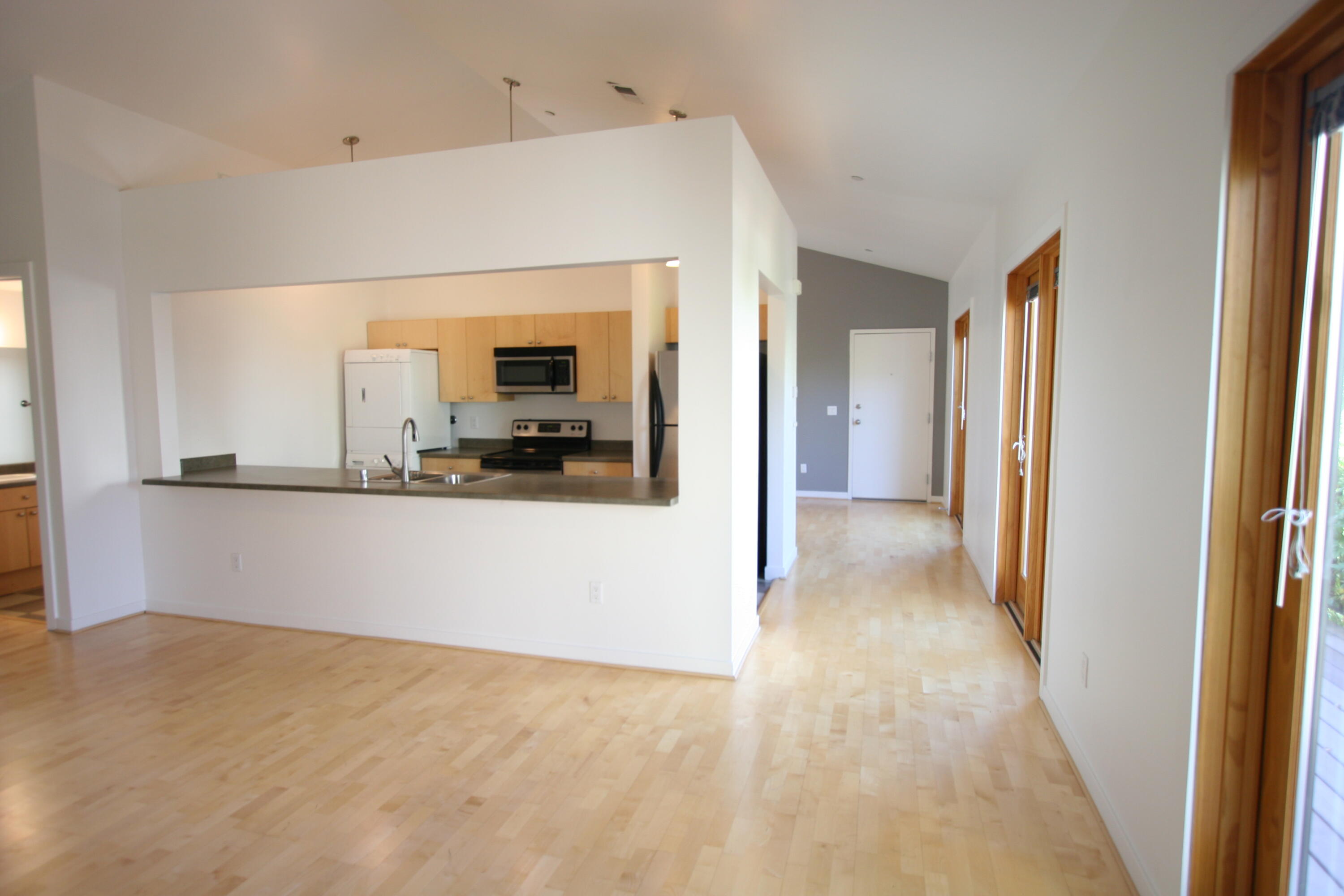 Charming one-bedroom, one-bath courthome at BelVedere offers modern living with thoughtful details. The L-shaped kitchen features stainless steel  refrigerator, oven, microwave, dishwasher, and disposal, complemented by warm maple cabinetry. Beautiful maple wood floors flow through the living area, while east and west-facing Pella windows fill the space with natural light. Full-size washer and dryer included for convenience. Residents enjoy secure landscaped courtyards with outdoor fireplaces, fountains, community grill, and seating areas. One assigned parking space included. Perfectly positioned near University of New Mexico, hospitals, and Rail Runner station. Downtown amenities and restaurants are just minutes away, making this an ideal urban retreat.