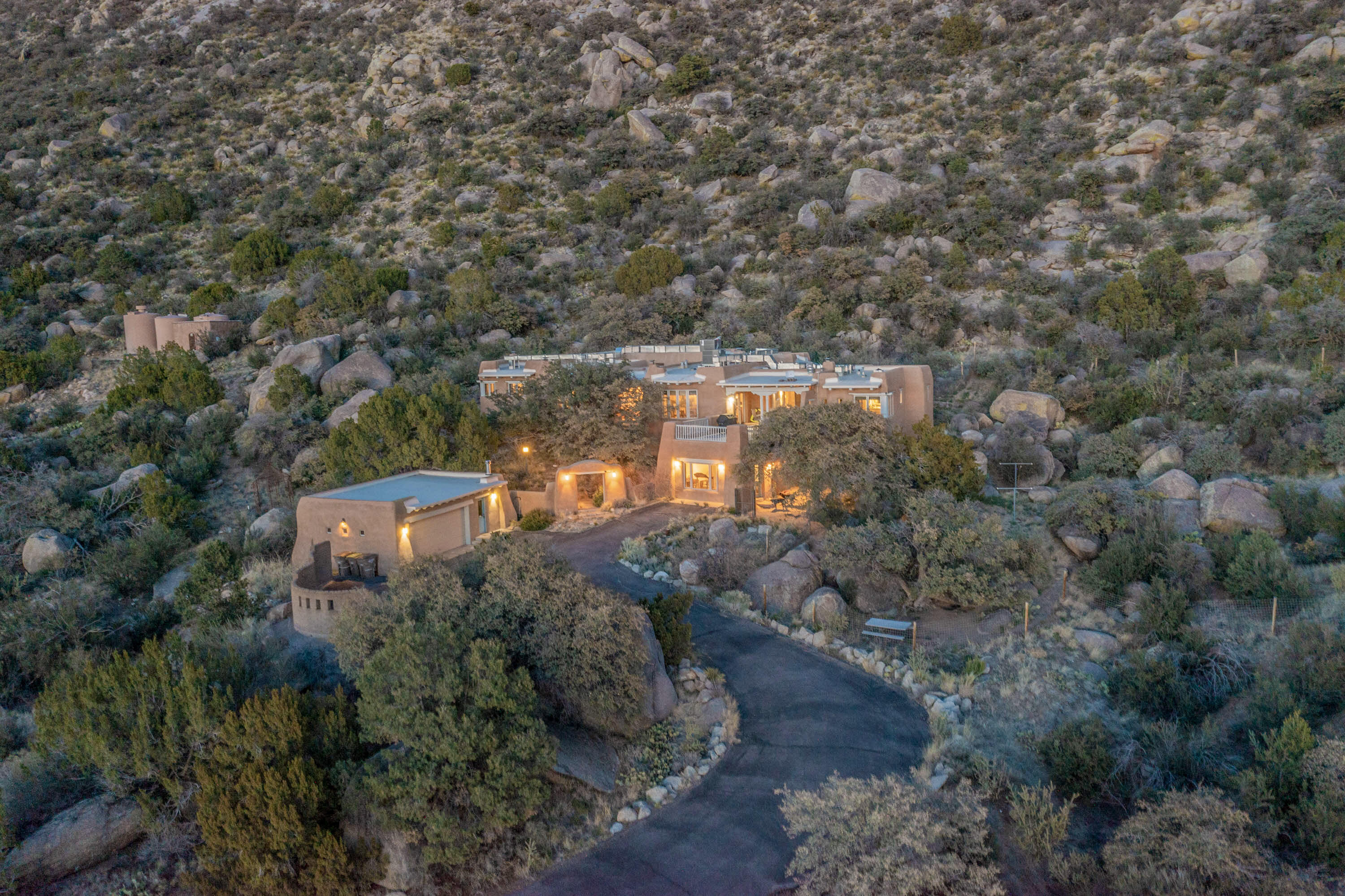 This Charming and authentic Adobe home in Tierra Monte offers a rare blend of luxury living and natural splendor at the base of the iconic Sandia Mountains. This spacious 3,680 sq. ft. residence is thoughtfully designed with updated roofing and mechanical systems, ensuring both comfort and elegance. Step inside to discover adobe construction, beamed ceilings, and a gourmet kitchen featuring a massive granite island, a veggie sink, a Viking gas range and double ovens, a Sub-Zero fridge/freezer, and an incredible deck off the kitchen and the primary bedroom suite, perfect for entertaining or relaxing after a long week.  The interior boasts five fireplaces, brick, Saltillo, and carpet flooring, and windows that frame breathtaking vistas. Set on a private lot, the home offers unparalleled....