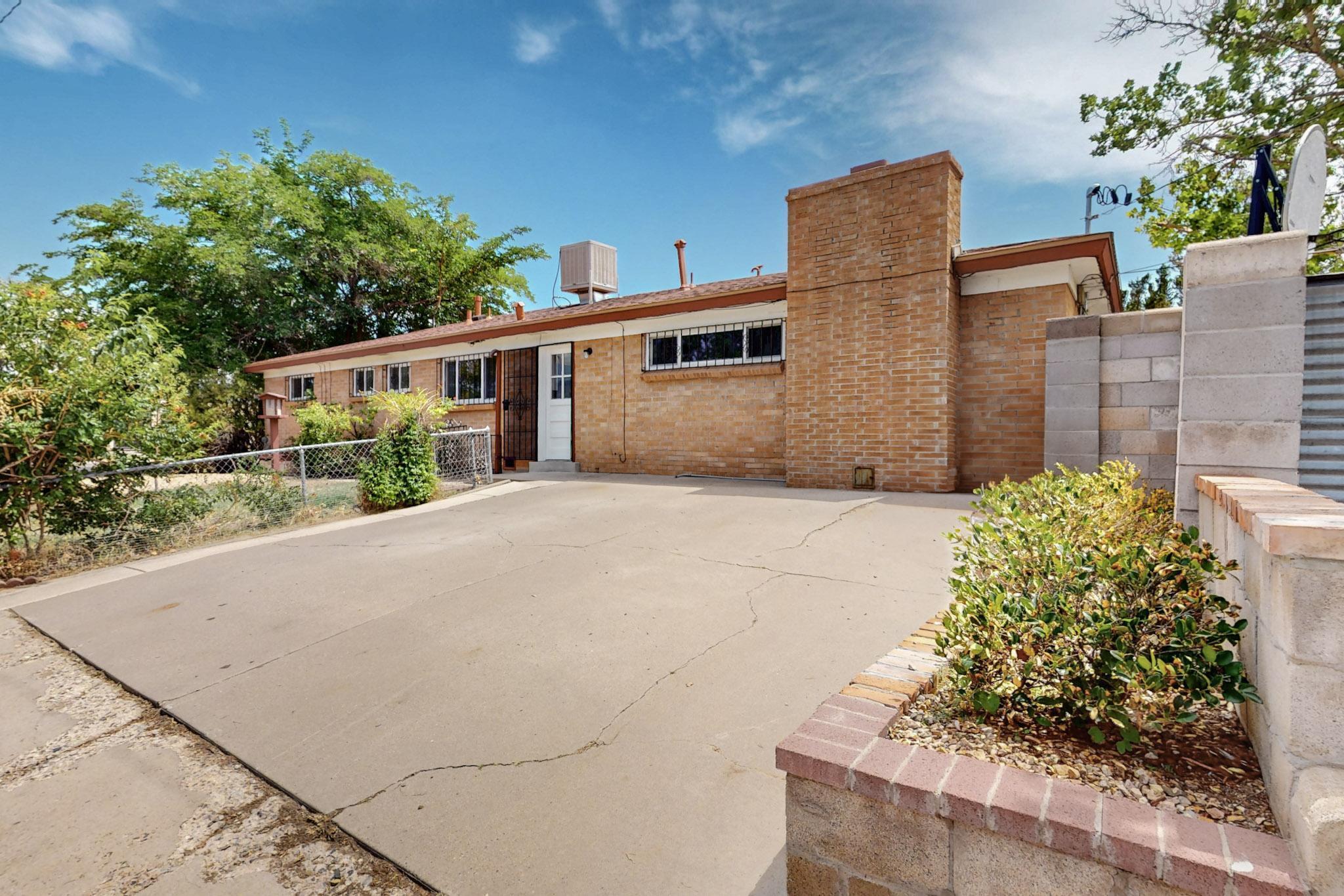 Charming brick home on a corner lot, beautifully updated with fresh paint, natural wood flooring, and brand-new appliances. The spacious secondary living room offers extra versatility, while modern touches like updated light fixtures and GFCI outlets enhance safety. A new roof, tankless water heater, and convenient backyard access add to the appeal. Enjoy a fantastic outdoor space for entertaining, plus a shop/storage building. Mature landscaping, a cozy brick fireplace, and a prime location make this home a must-see!